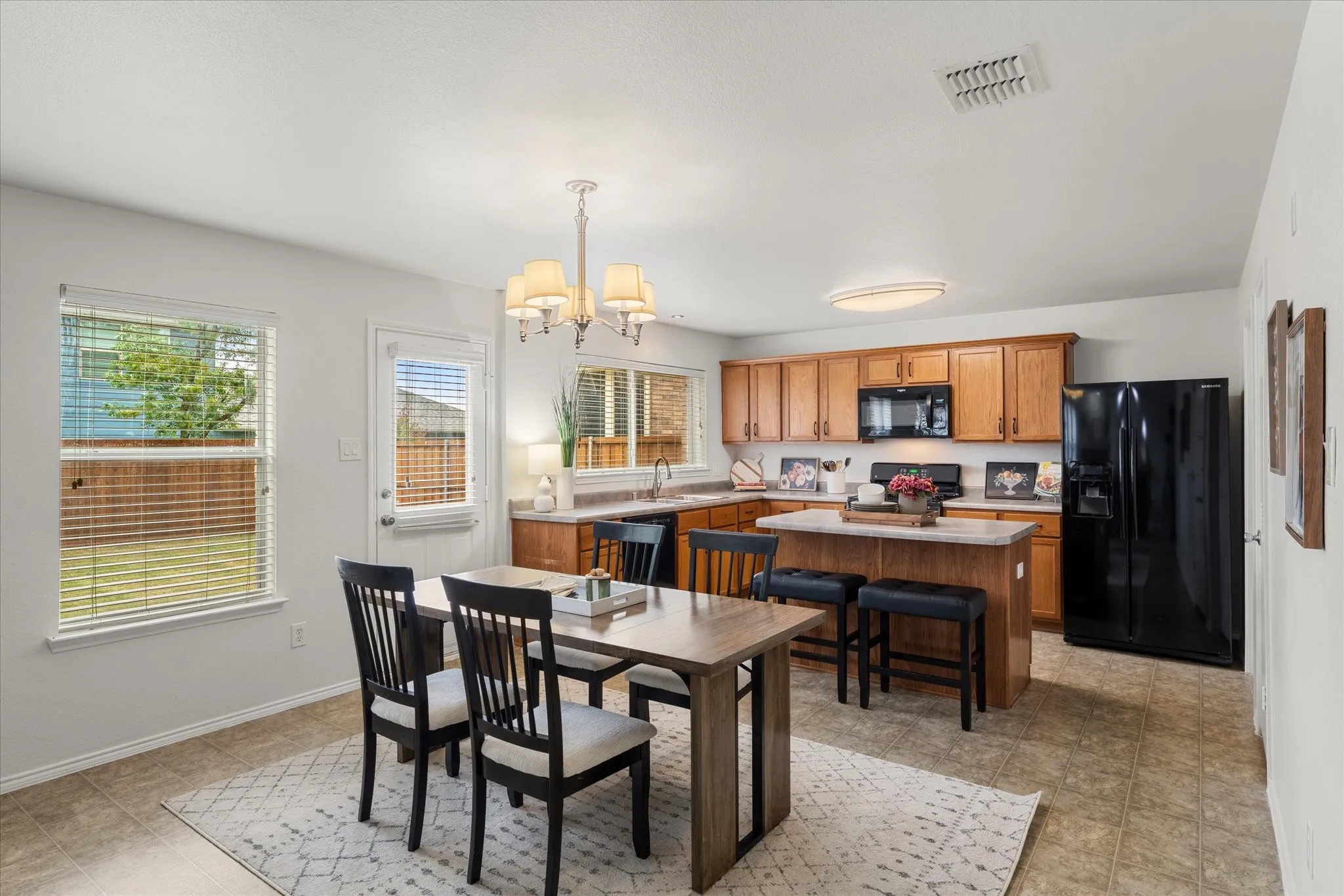 Adjacent to the kitchen, the dining area comfortably accommodates large gatherings, making it ideal for holiday dinners or weekend brunches.