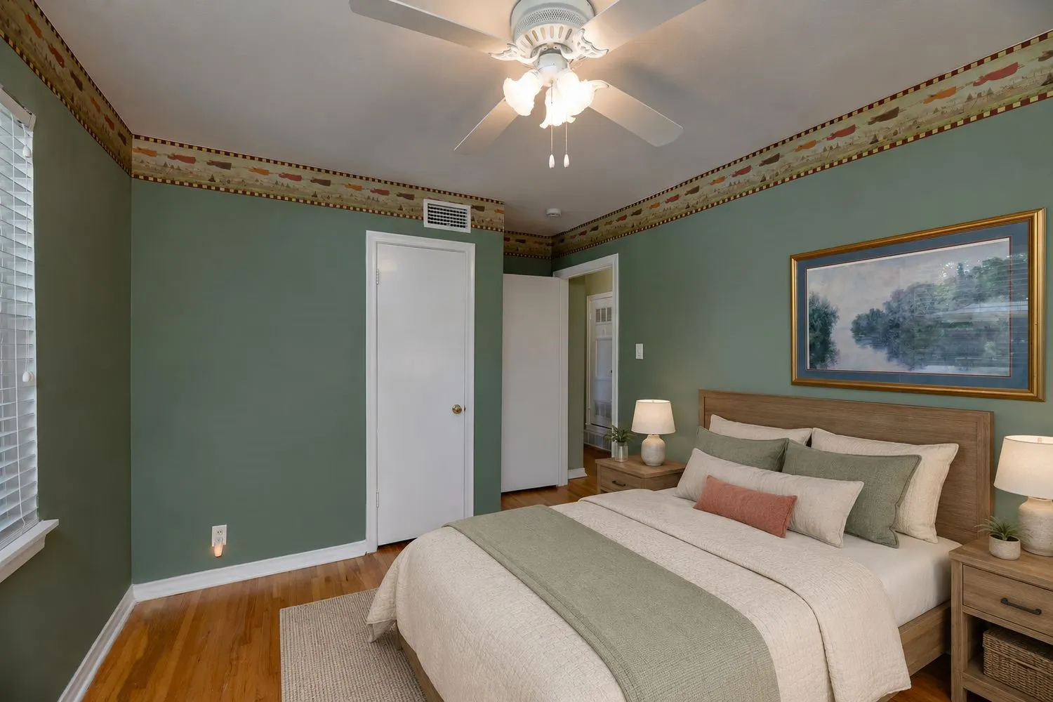 Virtually Staged - Bedroom featuring wood-finish flooring, a ceiling fan with integrated lighting, and a white door