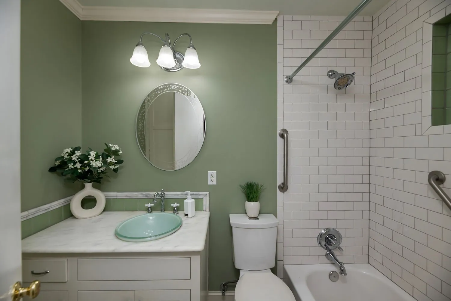 Bathroom featuring a white subway tile shower, a white bathtub, and brushed nickel fixtures