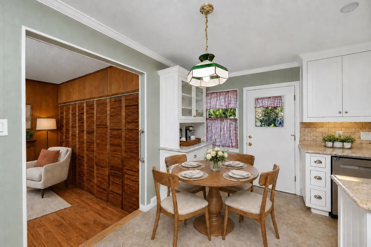 Virtually Staged - Eat-in kitchen featuring light-colored cabinetry, stone-finish countertops, and a subway tile backsplash