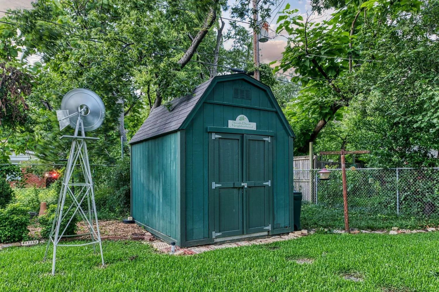 Storage shed keeps tools, lawn equipment, and seasonal items organized.
