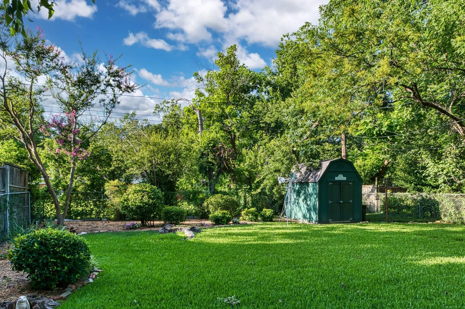 The spacious fenced backyard provides abundant, flexible outdoor potential.