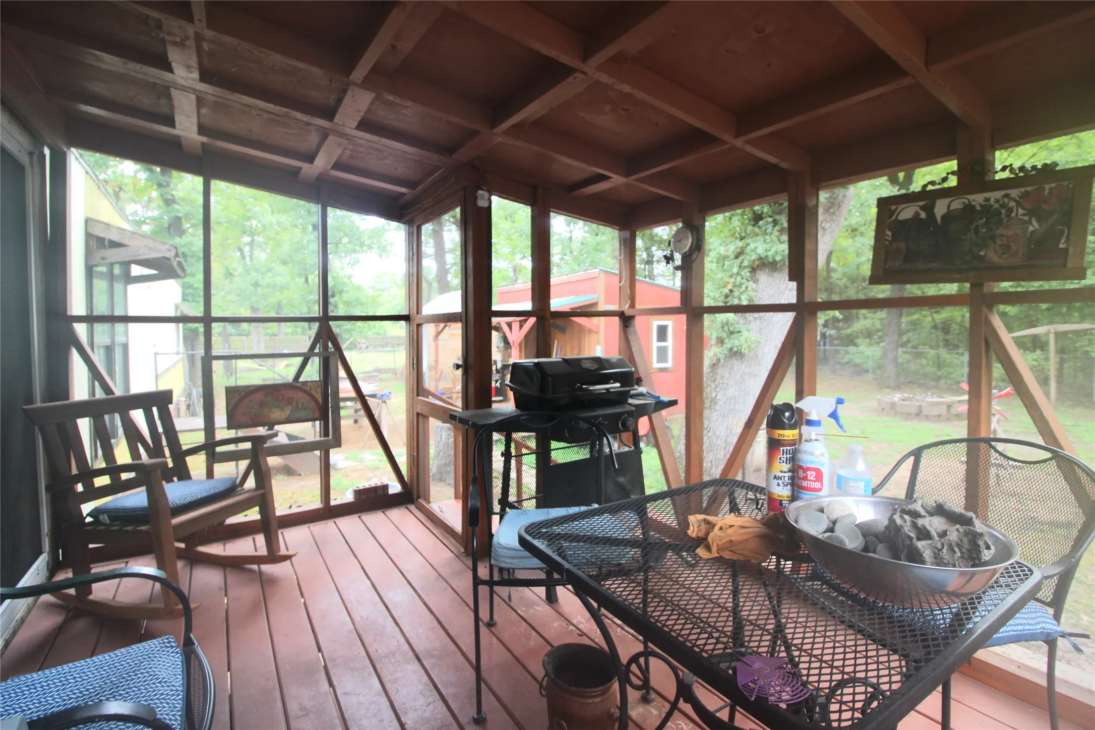 Screened porch featuring a wood-finish ceiling, wood-finish flooring, and a screened door