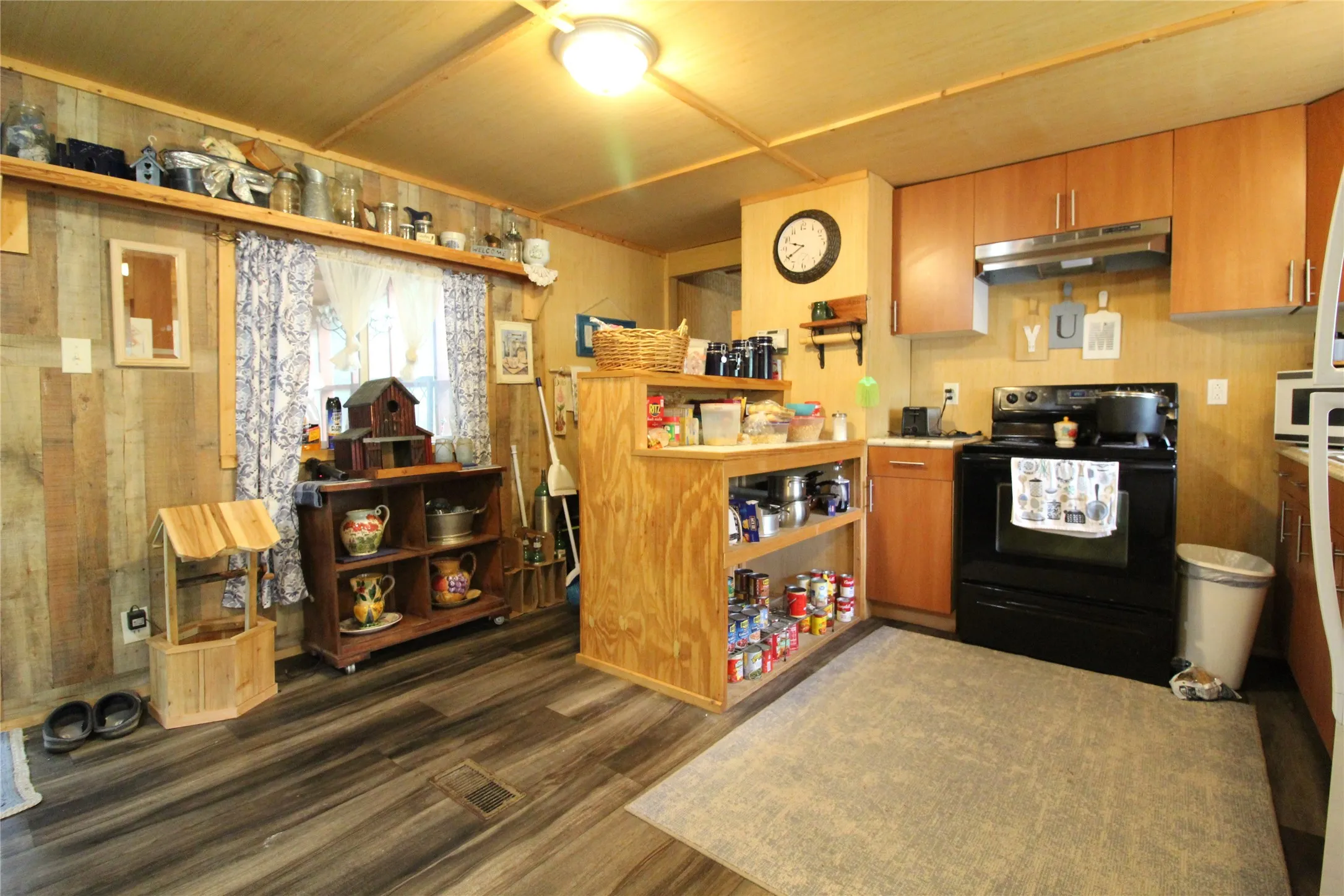 Kitchen featuring wood-finish flooring, wood plank paneling, and wood ceiling planks