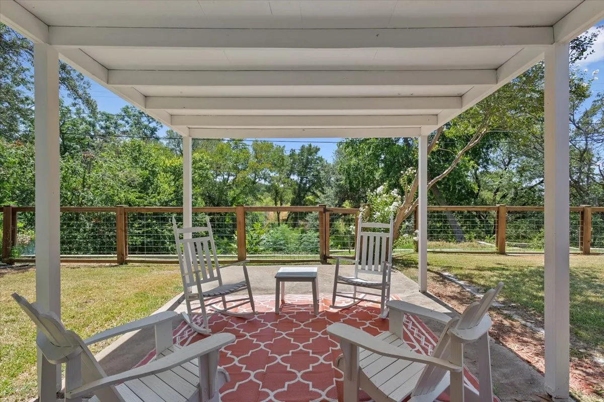 Covered patio featuring a concrete slab and white support columns