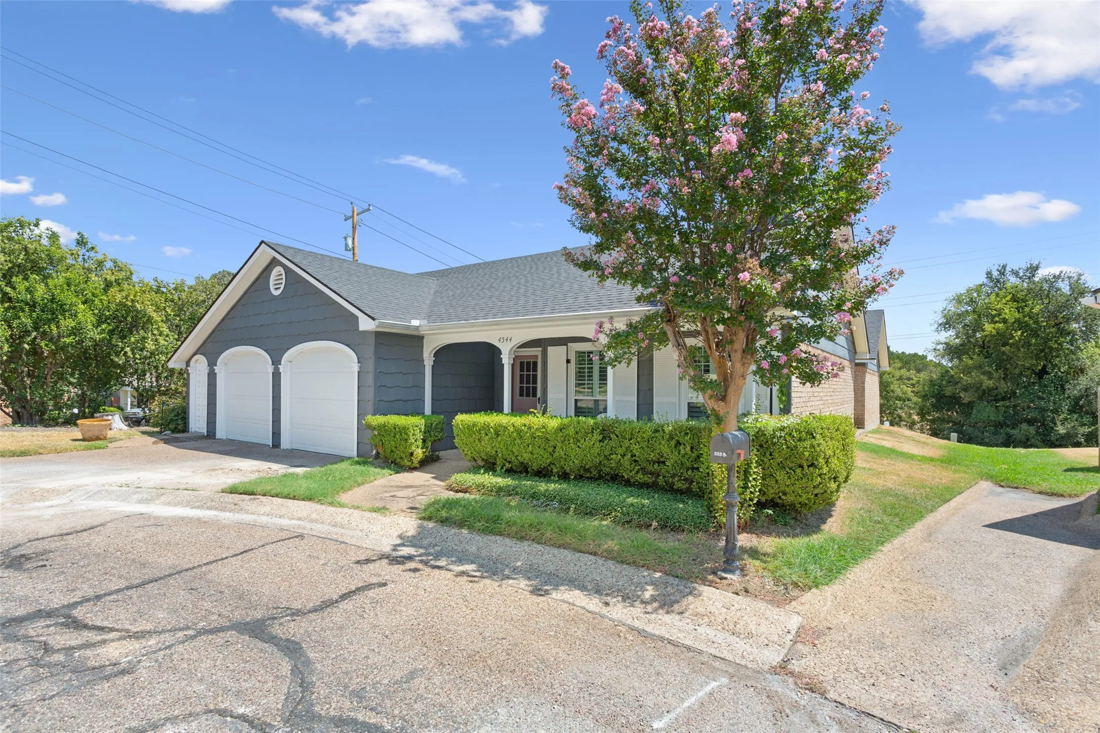 Dark gray siding exterior with white trim and a gabled roof