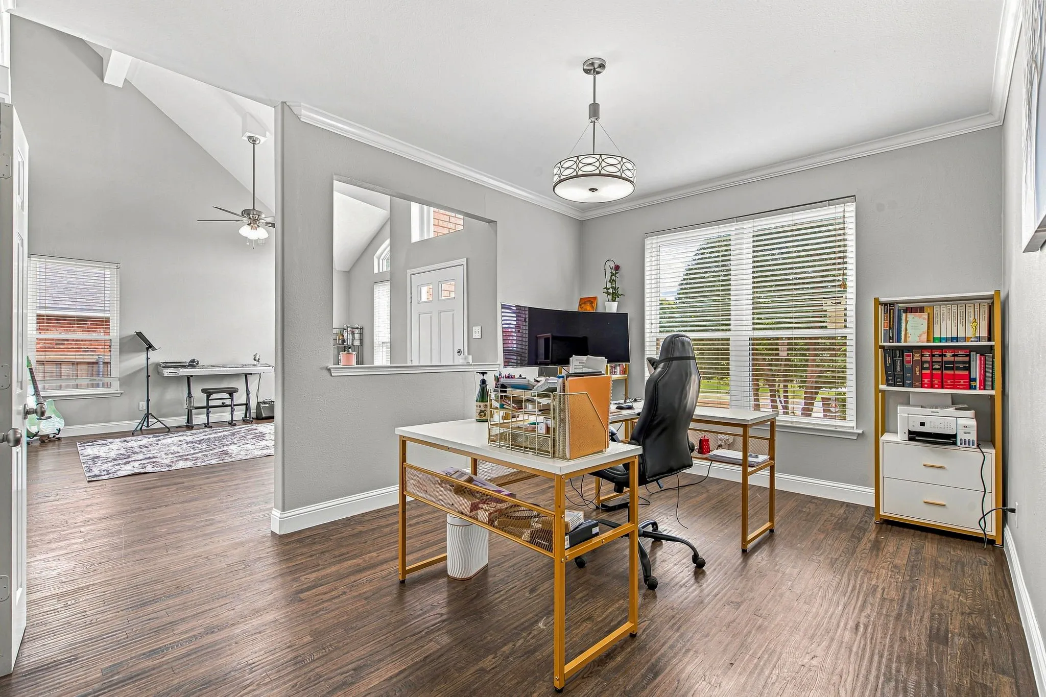 Wood-finish flooring throughout, with a recessed wall opening and a window featuring blinds