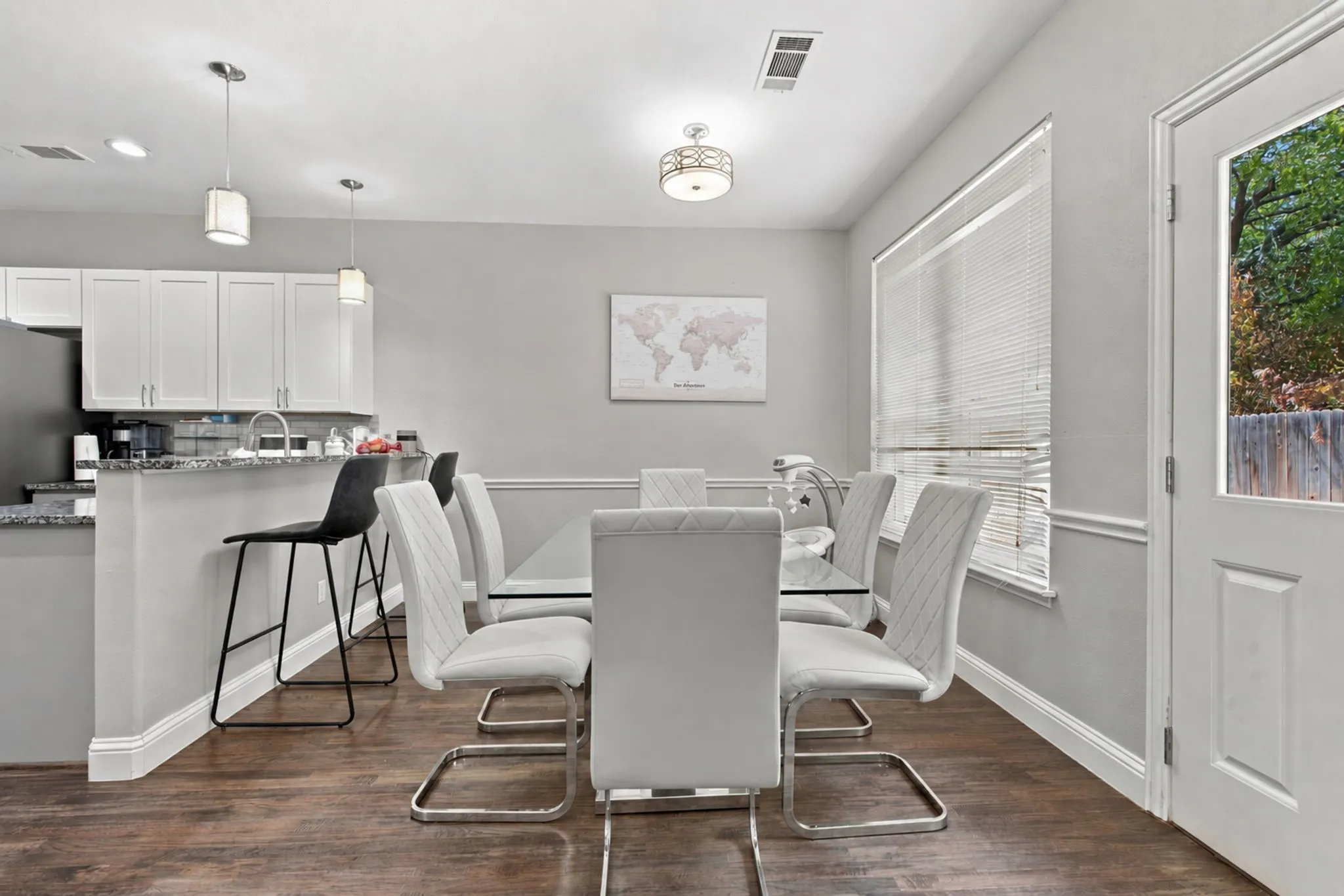 Galley kitchen with white cabinetry and dark countertops
