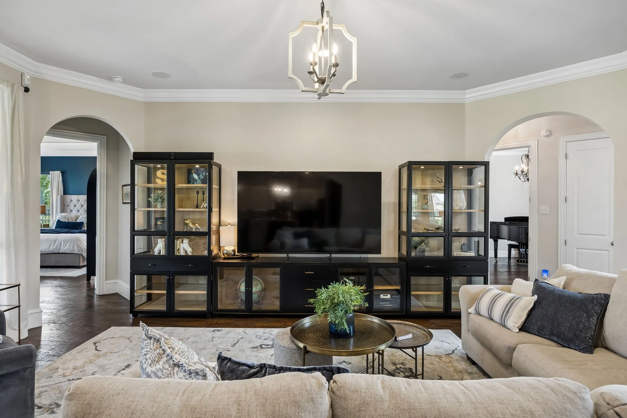 Spacious living area featuring dark wood-finish flooring and light-toned walls