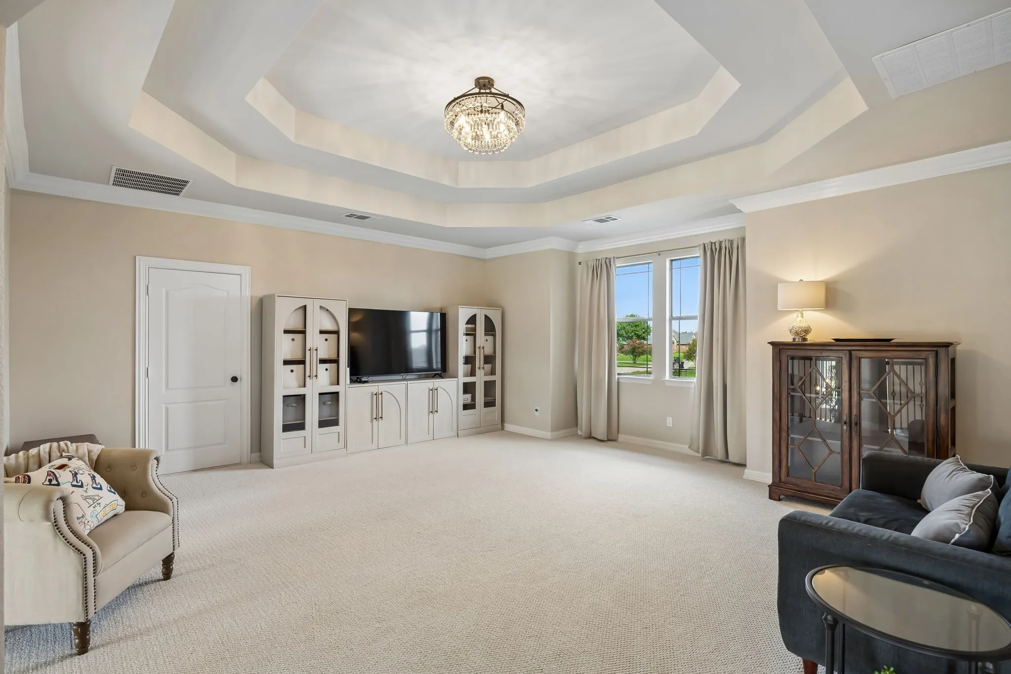 Upstairs game room with a trayed ceiling