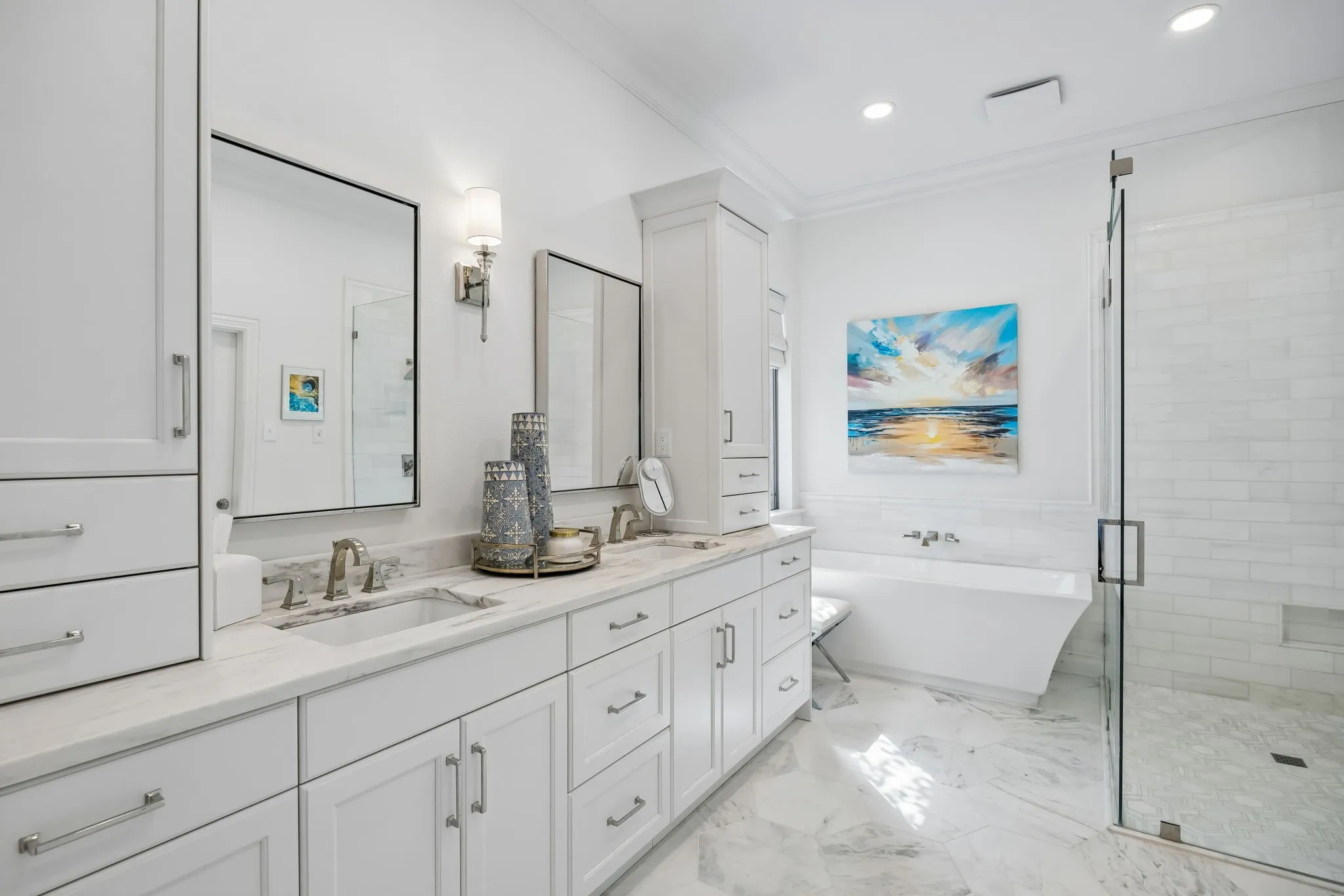 Ensuite primary bathroom featuring 2 sinks and plenty of storage.