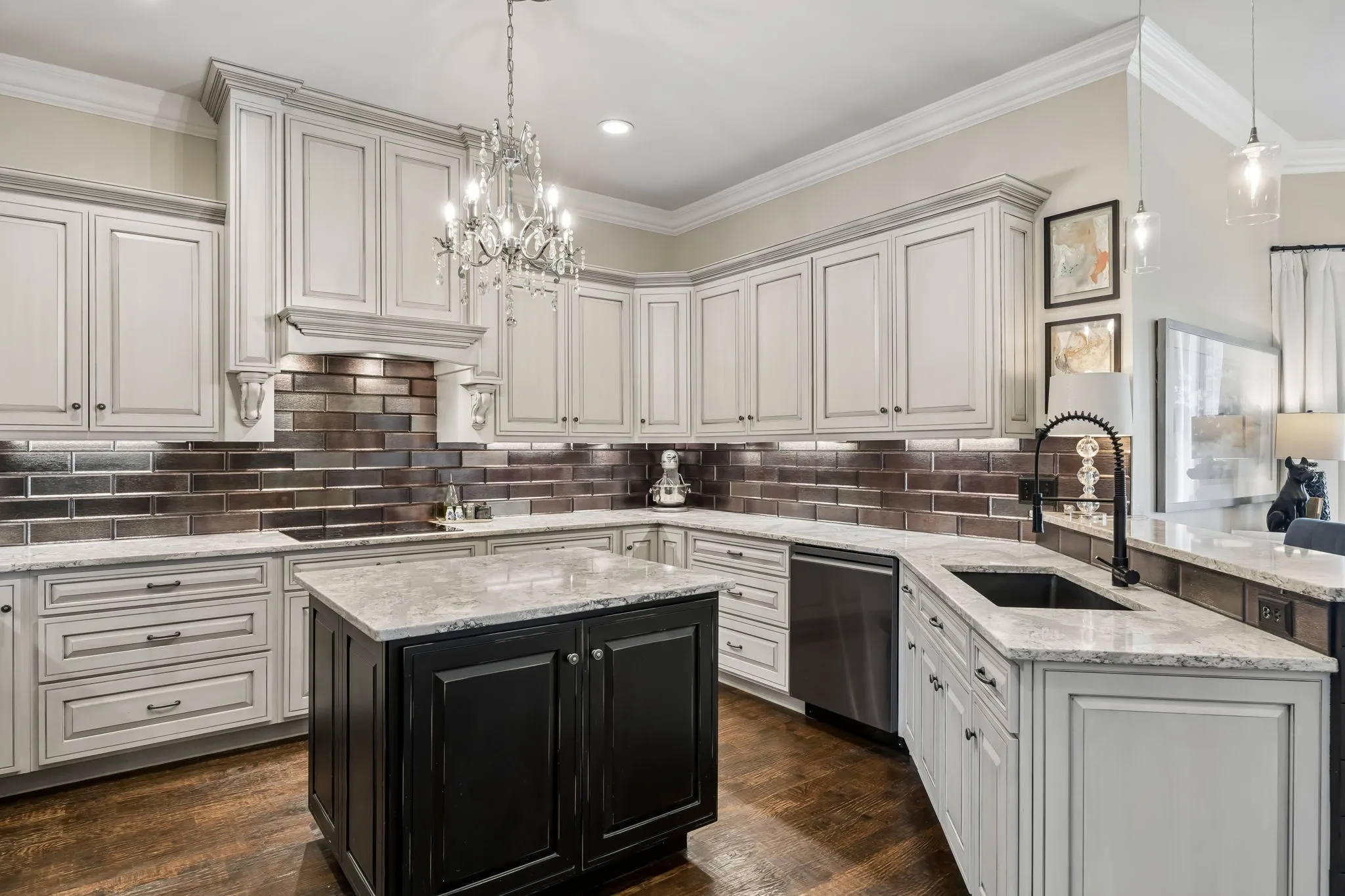 Gourmet kitchen featuring a central island, brown subway tile backsplash and stainless steel appliances