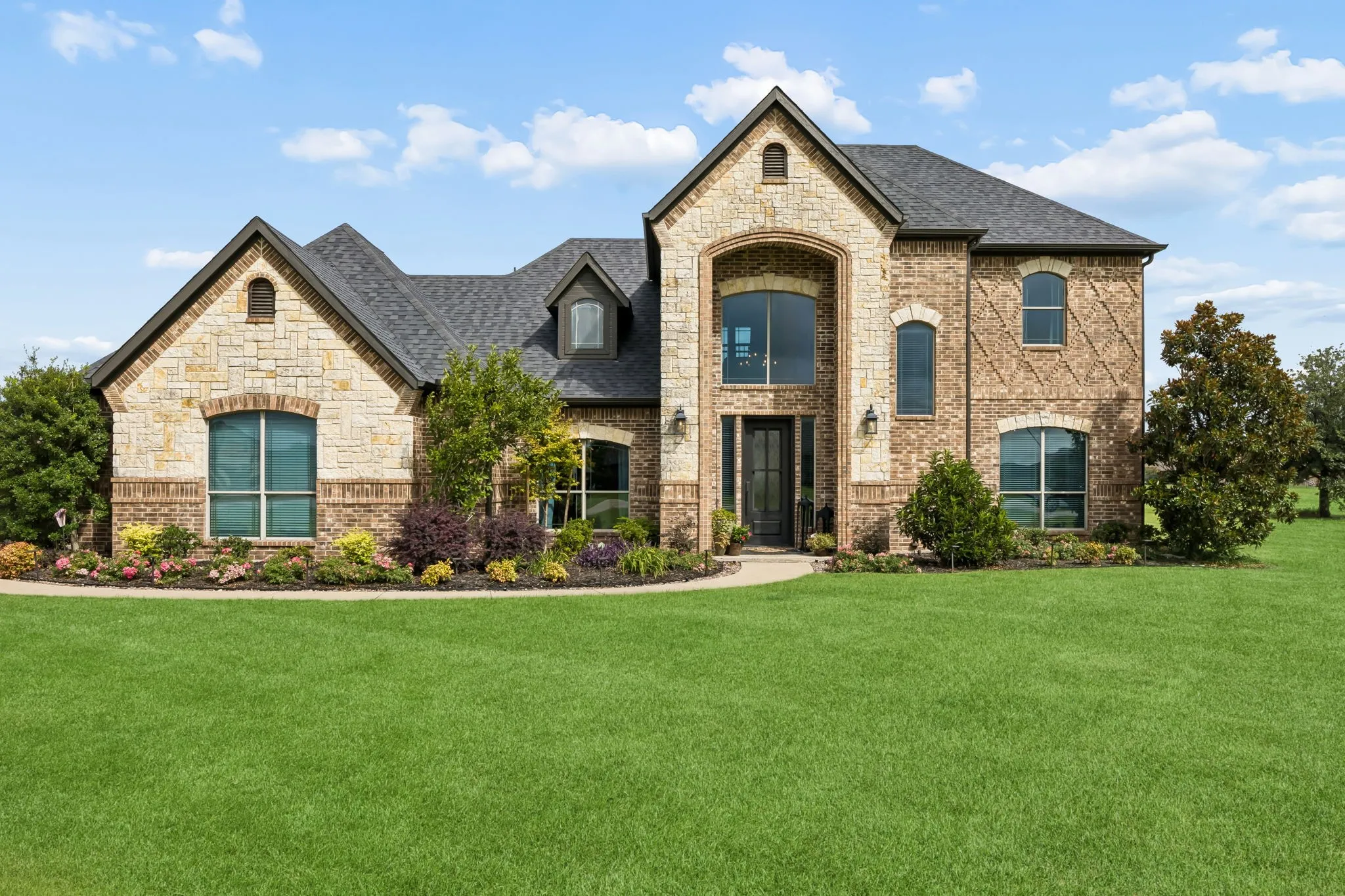 Stone and brick facade two story residence.