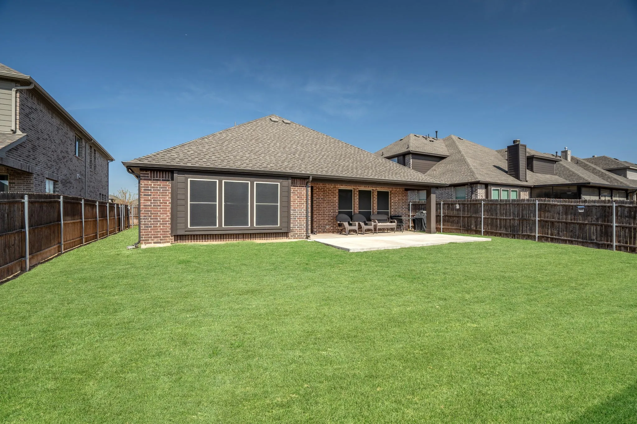 Spacious back yard with covered, extended patio.