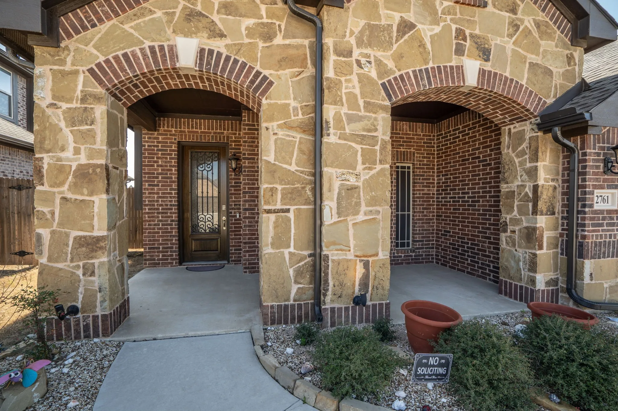 Beautiful front entry with covered patio.