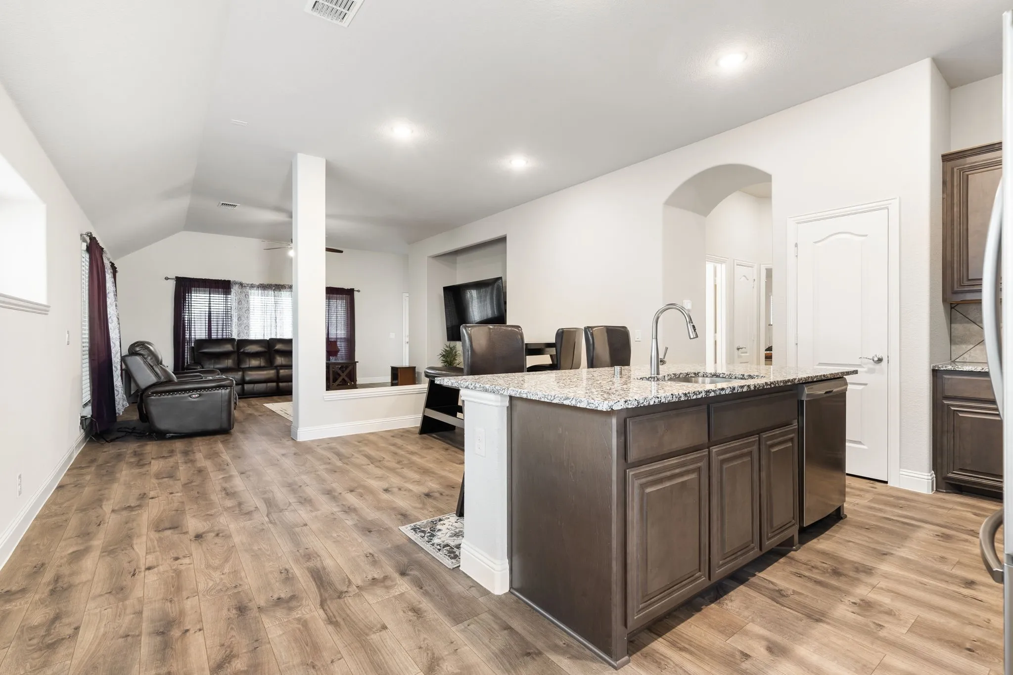 The kitchen flows seamlessly into the dining and living rooms.
