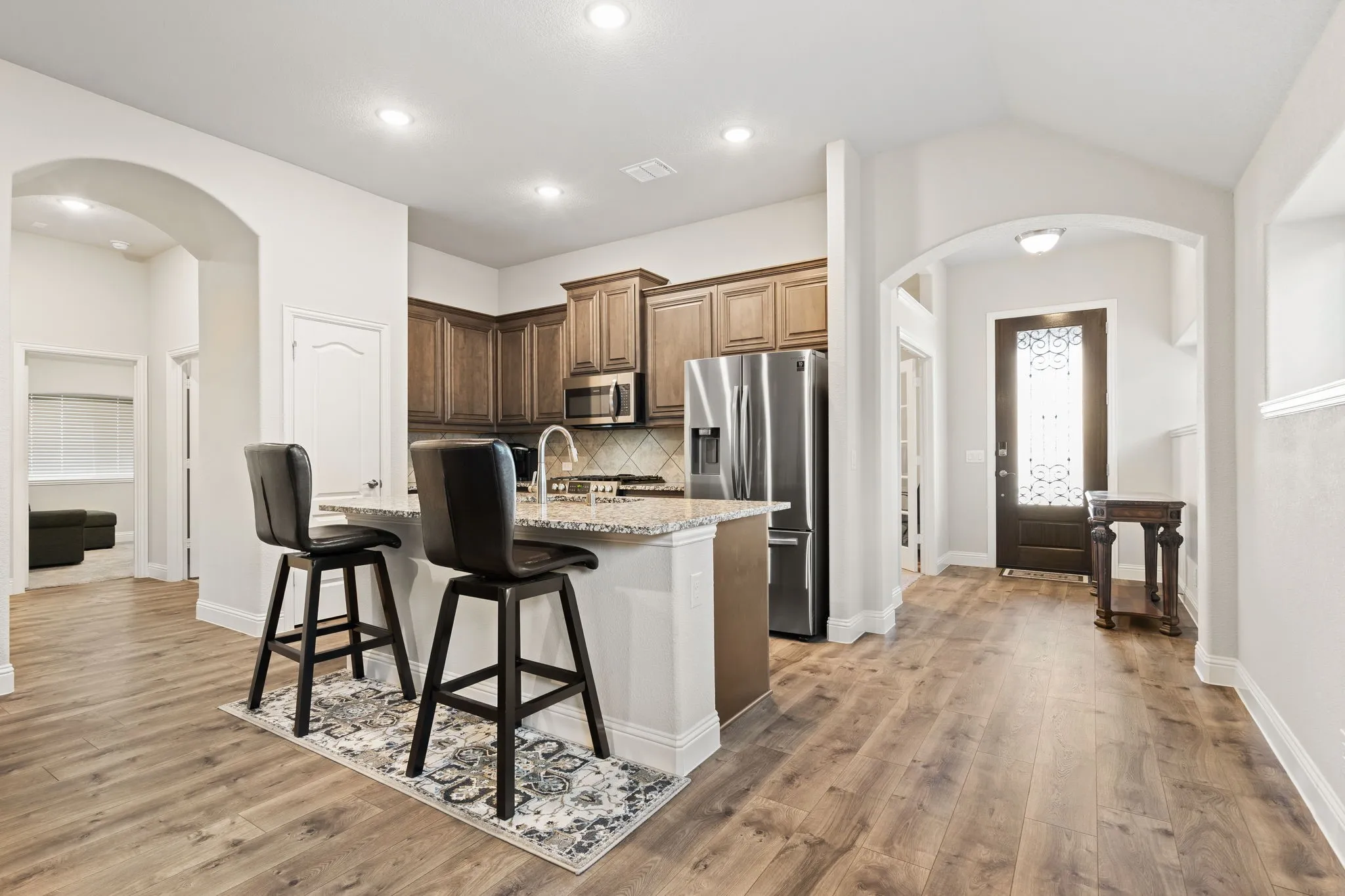 Open floorplan featuring a kitchen with breakfast bar.