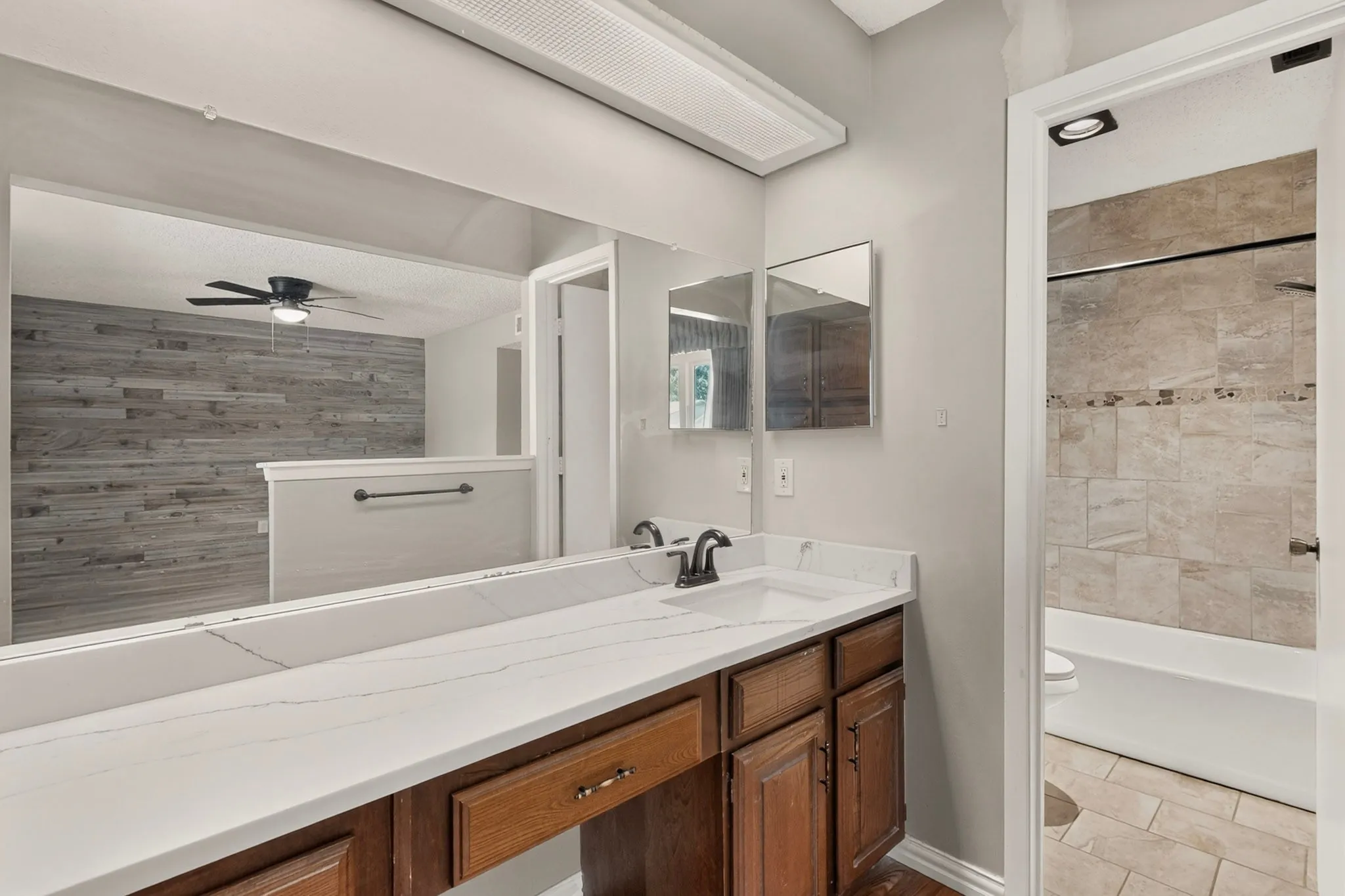 Dual vanity with a white countertop and integrated sinks