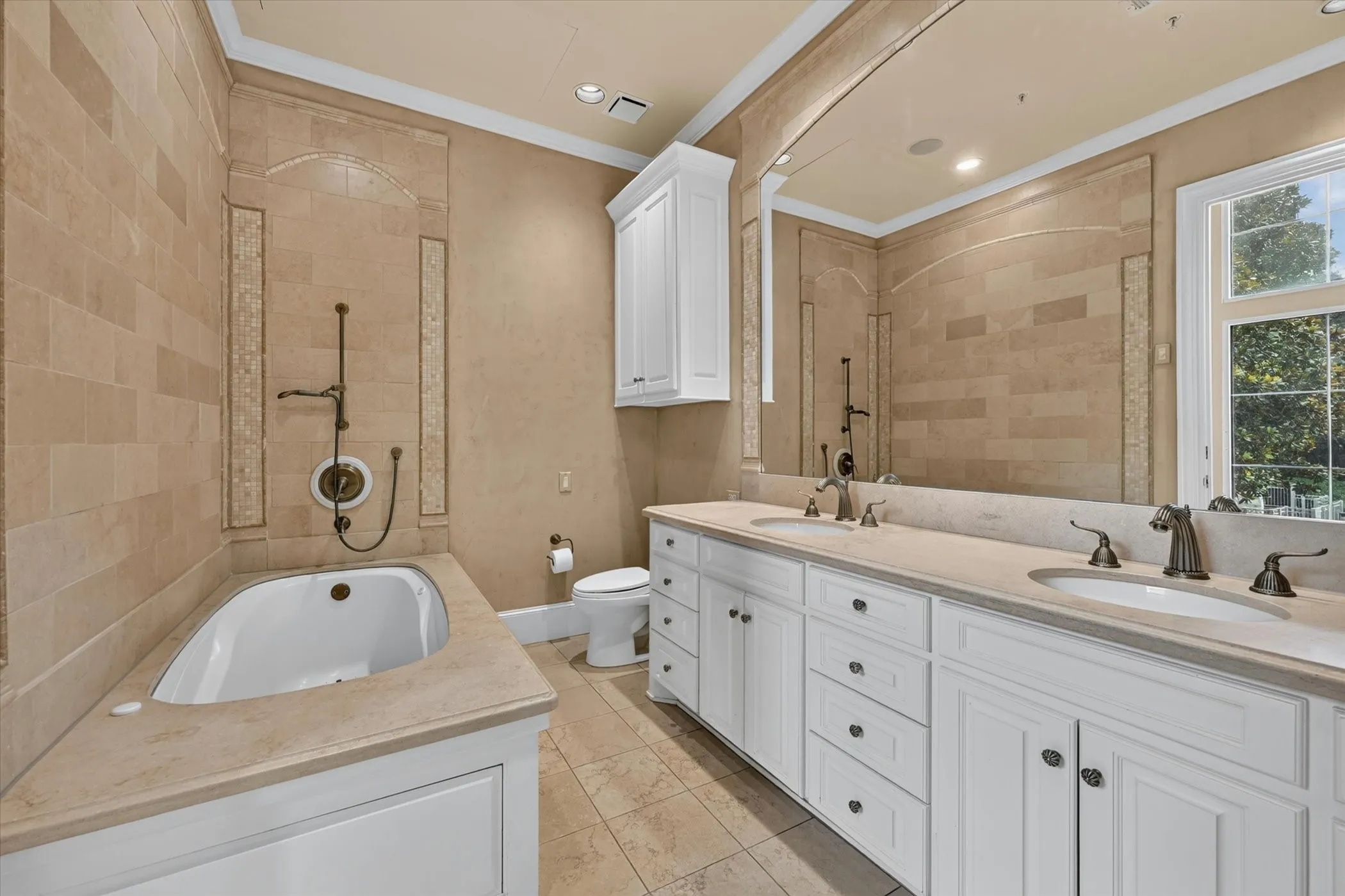 Marble counters, floors & walls & dual sinks in secondary Primary Bedroom.