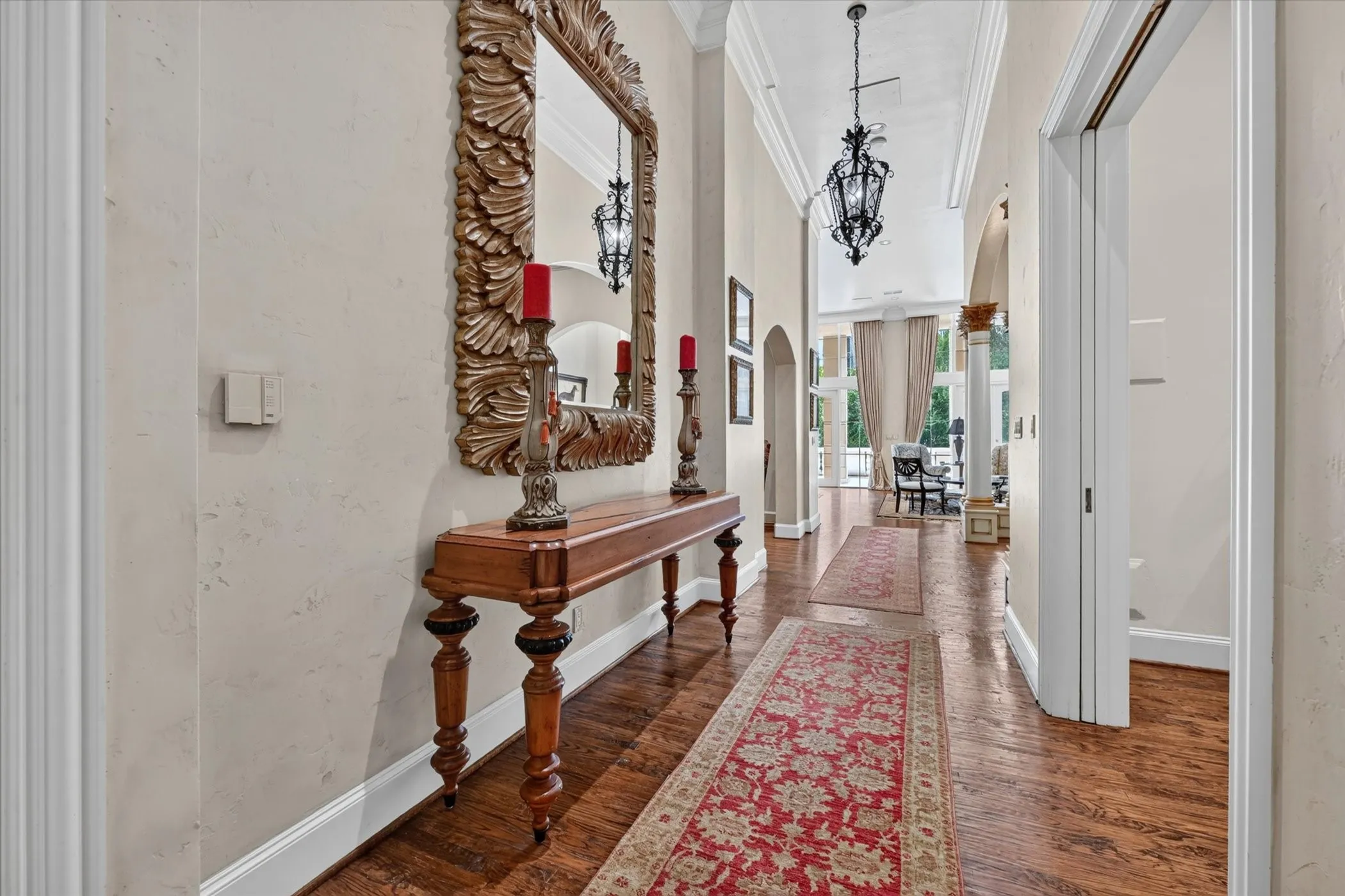 High ceilings & wood floors in Entry, flanked by Powder Bath & Den/Study.