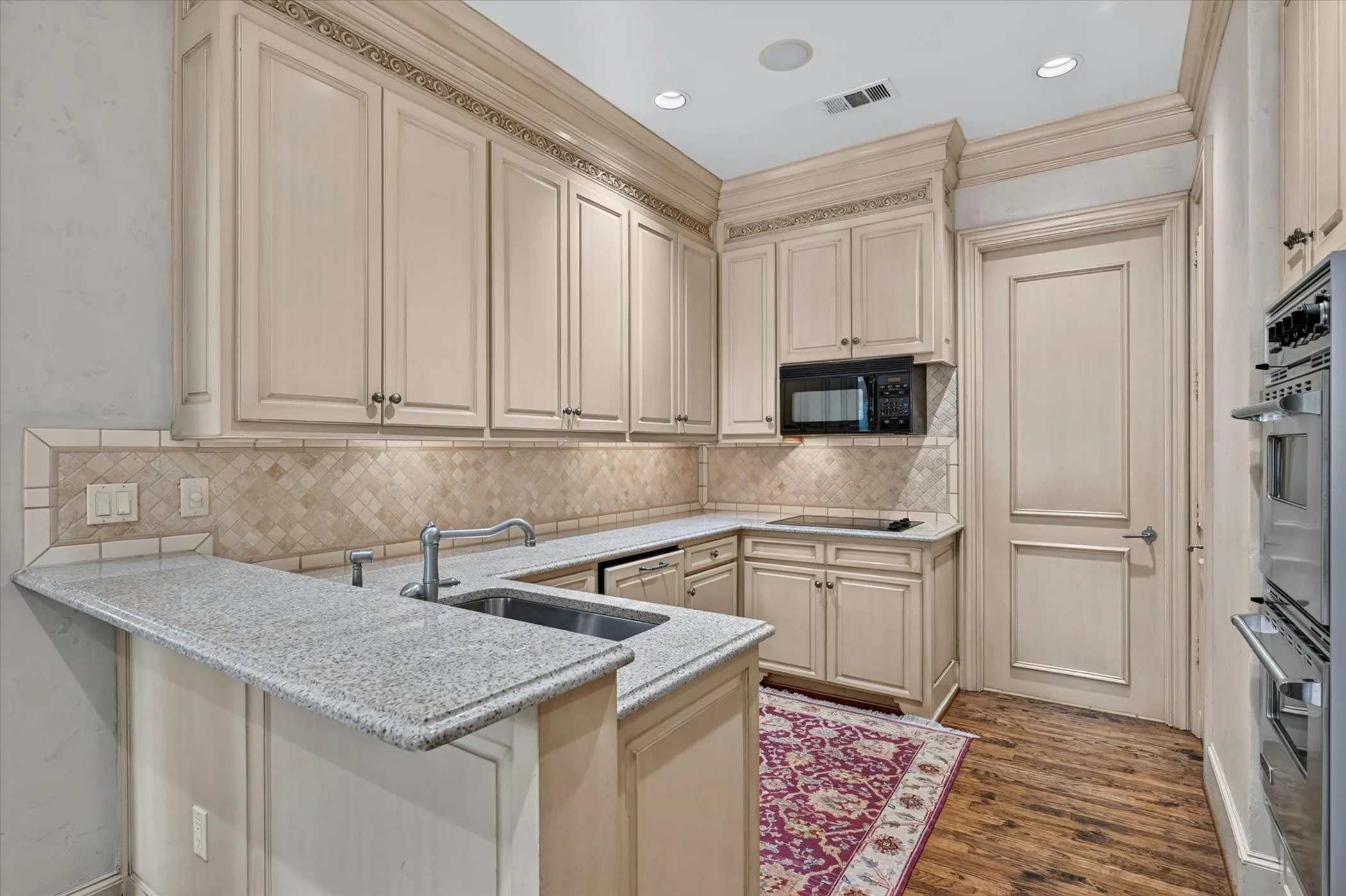 Double ovens, built-in refrigerator, farm sink & pantry grace the kitchen.