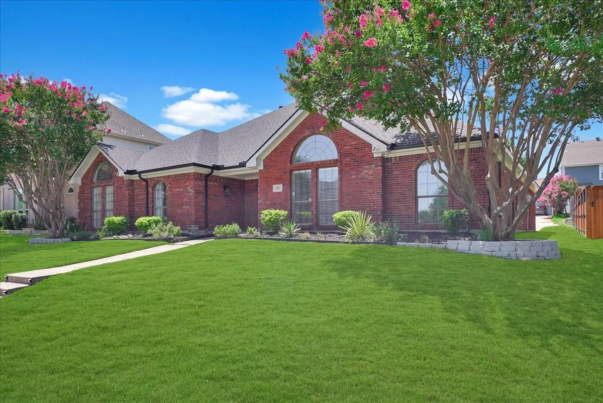 Brick exterior featuring arched windows and a prominent entry