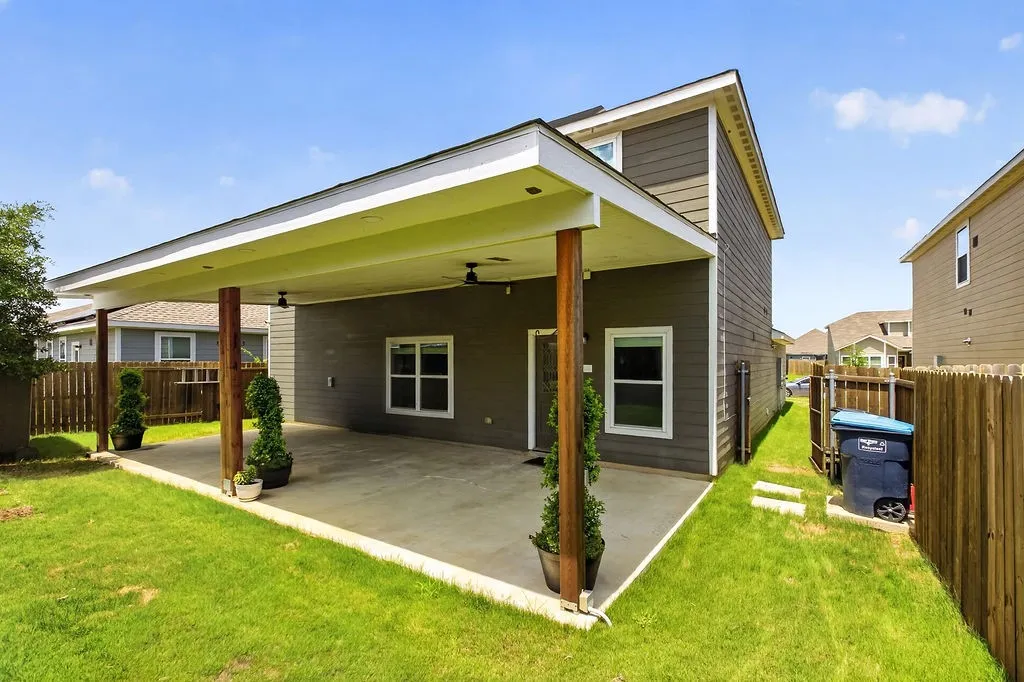 Expansive covered patio featuring concrete flooring, four wooden support columns, and recessed lighting