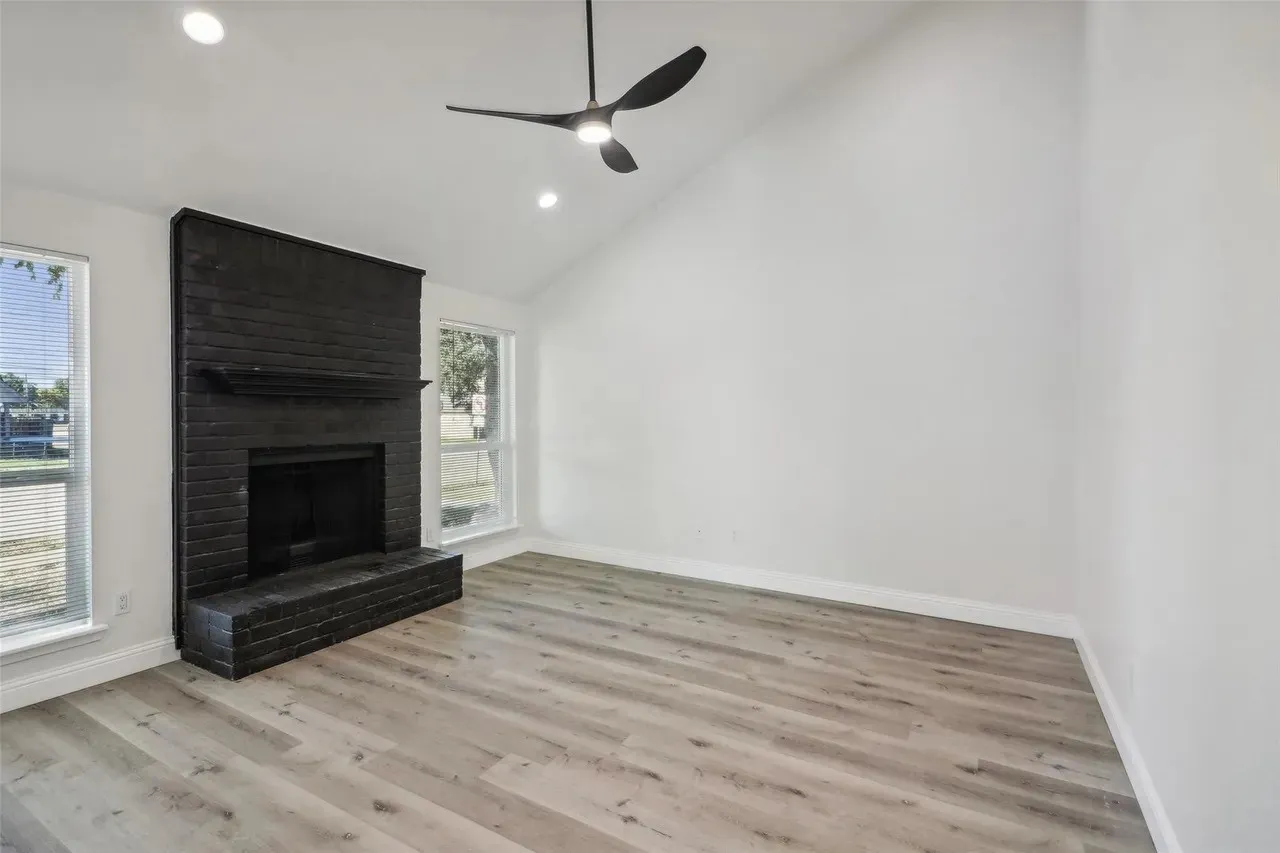 Vaulted ceilings complement the black brick fireplace