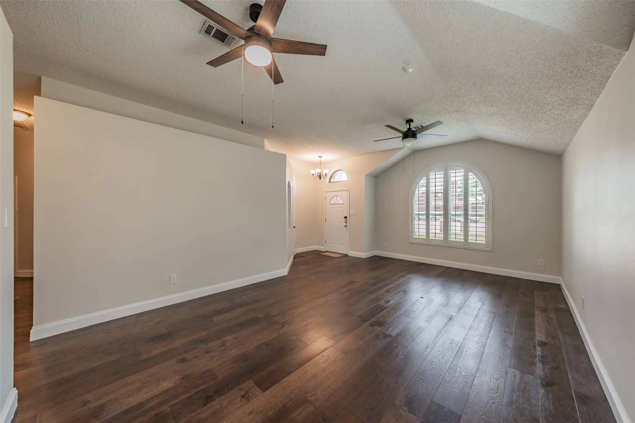 Living room is open to the formal dining room.  Plantation shutters in the windows offer privacy.