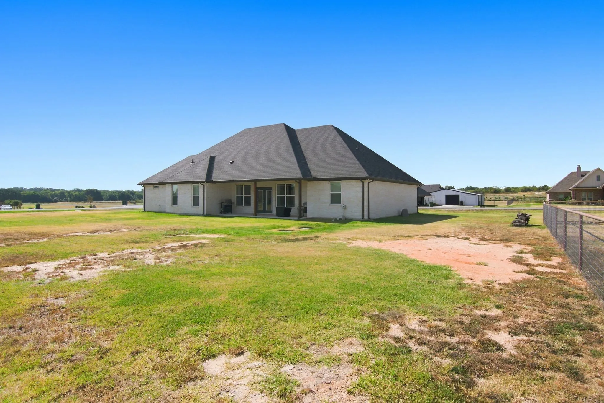 Expansive rear yard with a perimeter fence