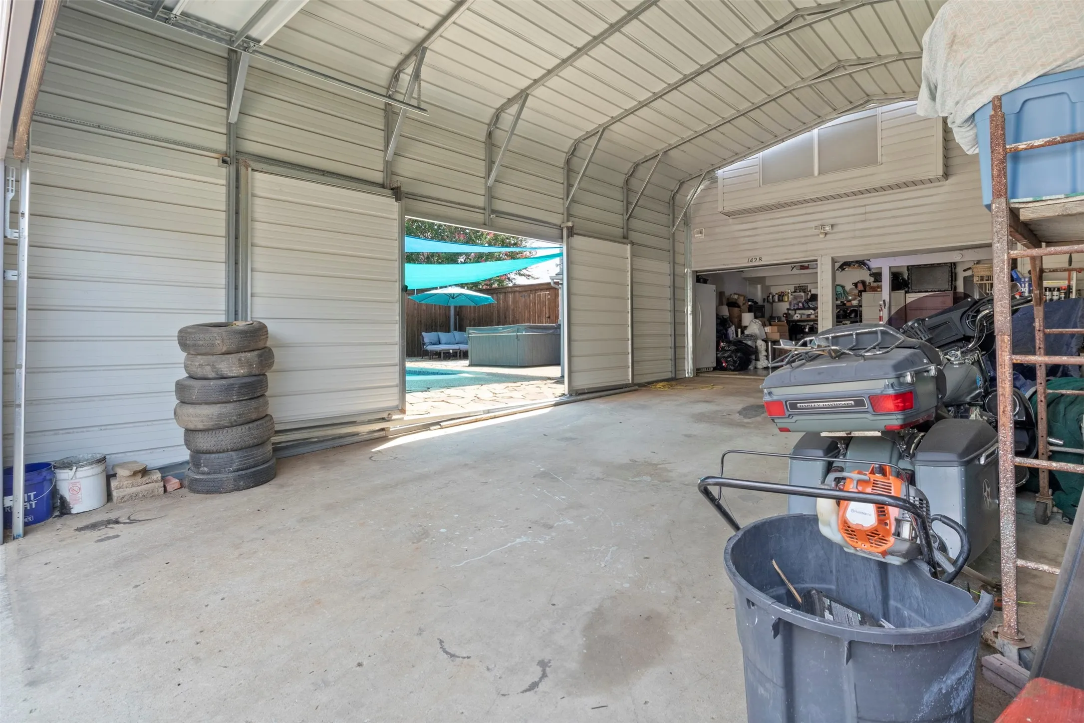Enclosed carport with door to the backyard