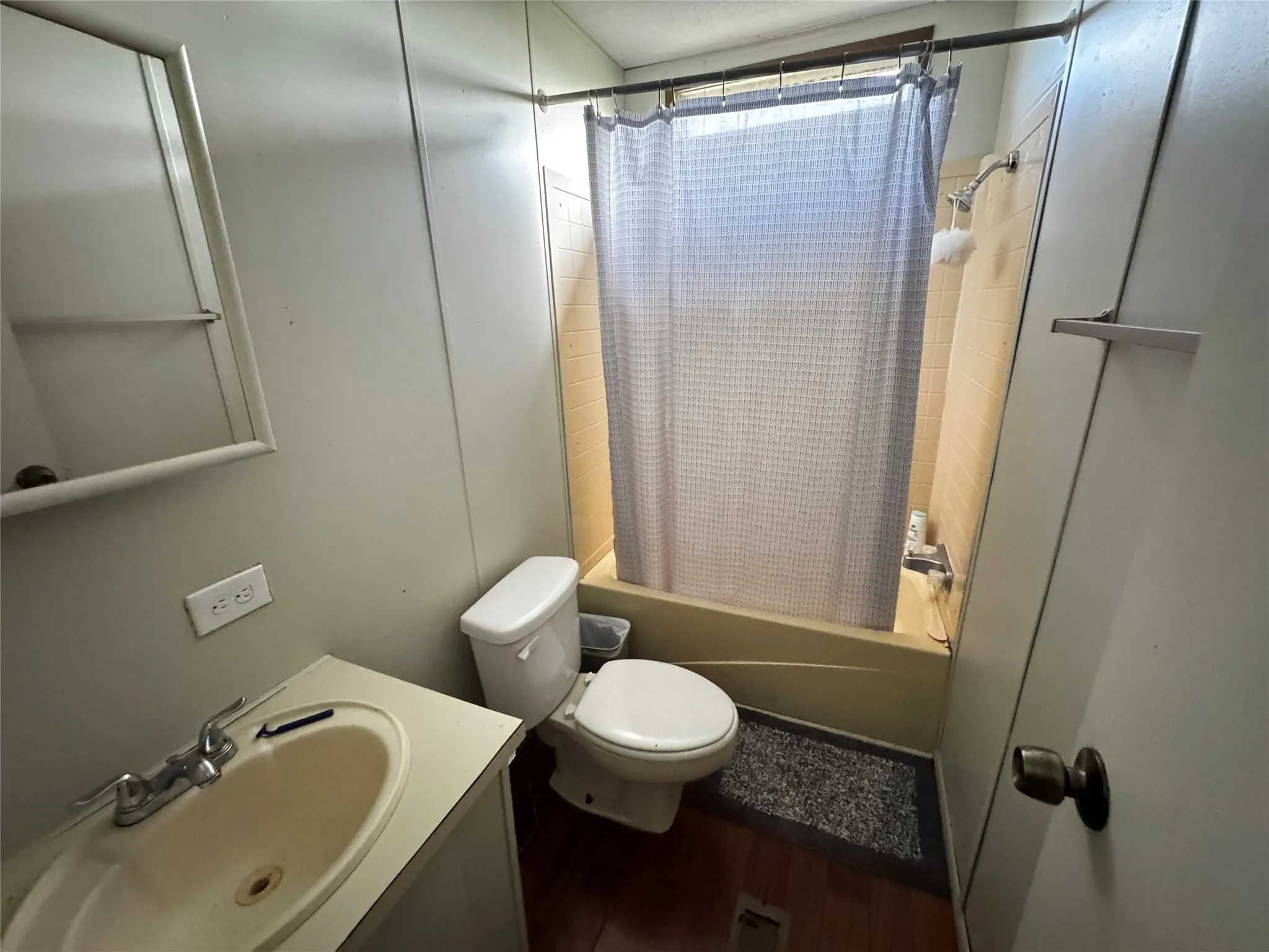 Bathroom featuring a built-in vanity with an integrated sink, a commode, and a tub with a shower fixture