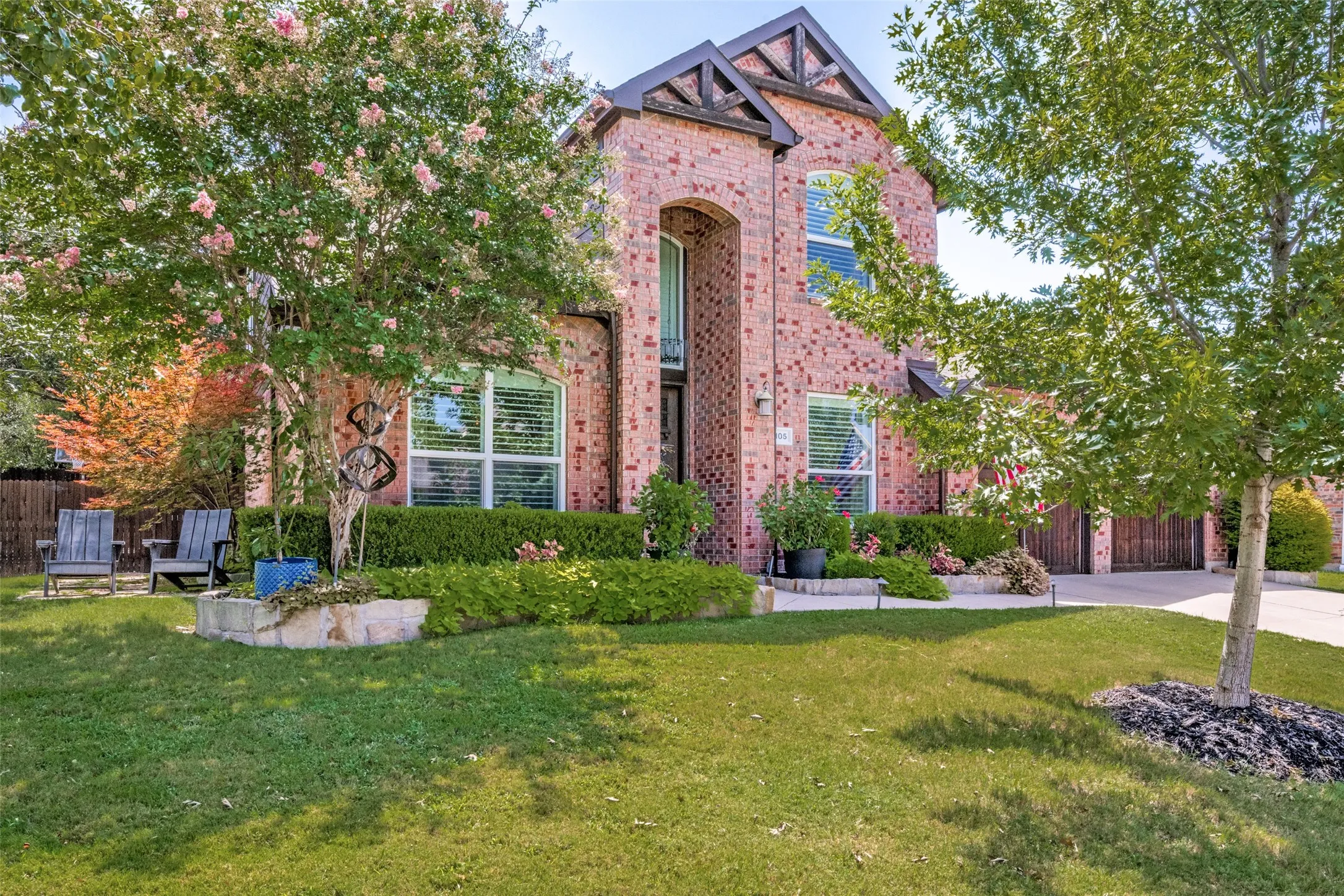 Brick facade residential structure featuring a prominent front gable with decorative trim