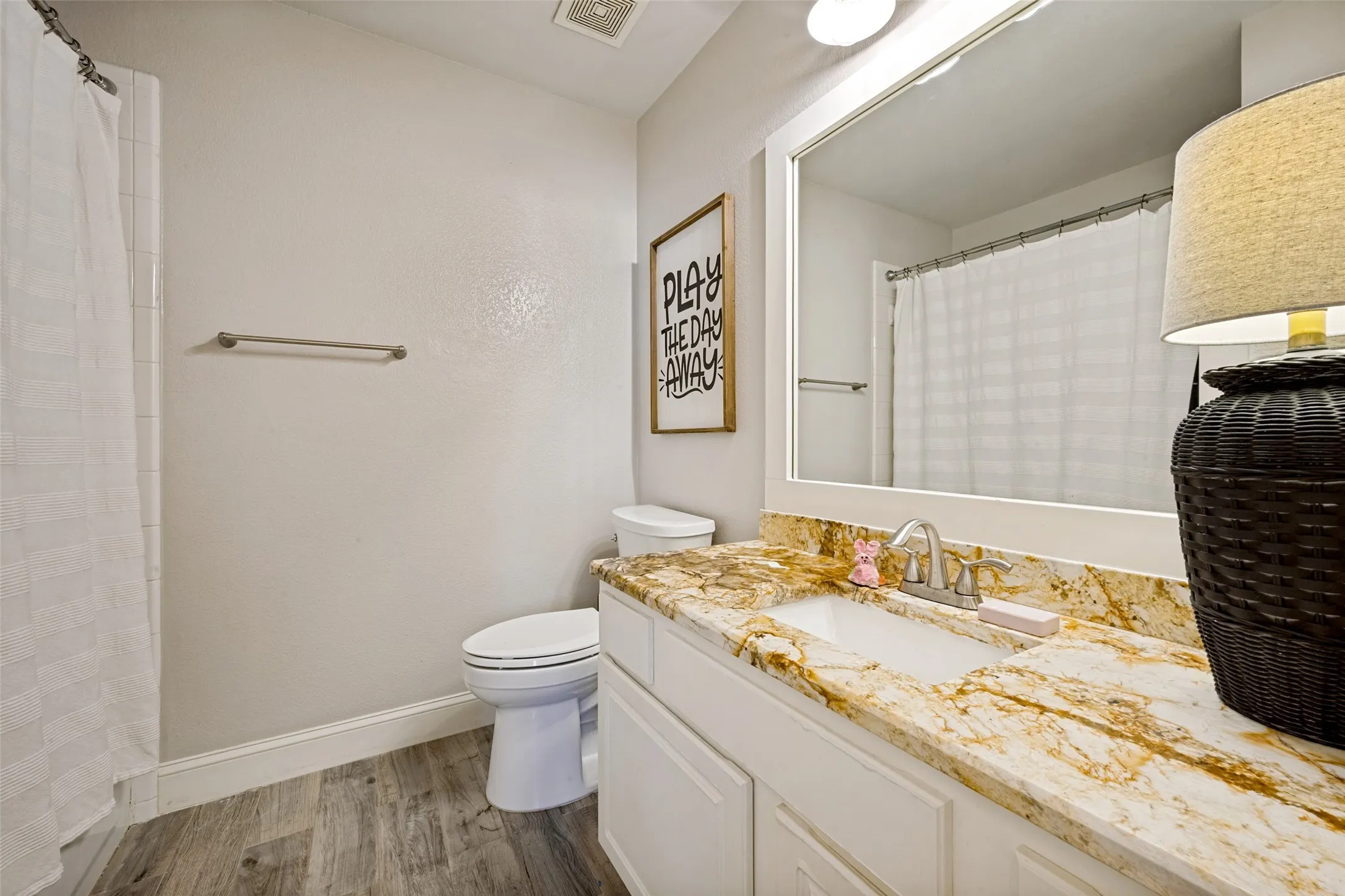 Bathroom vanity with a polished stone countertop and an undermount sink