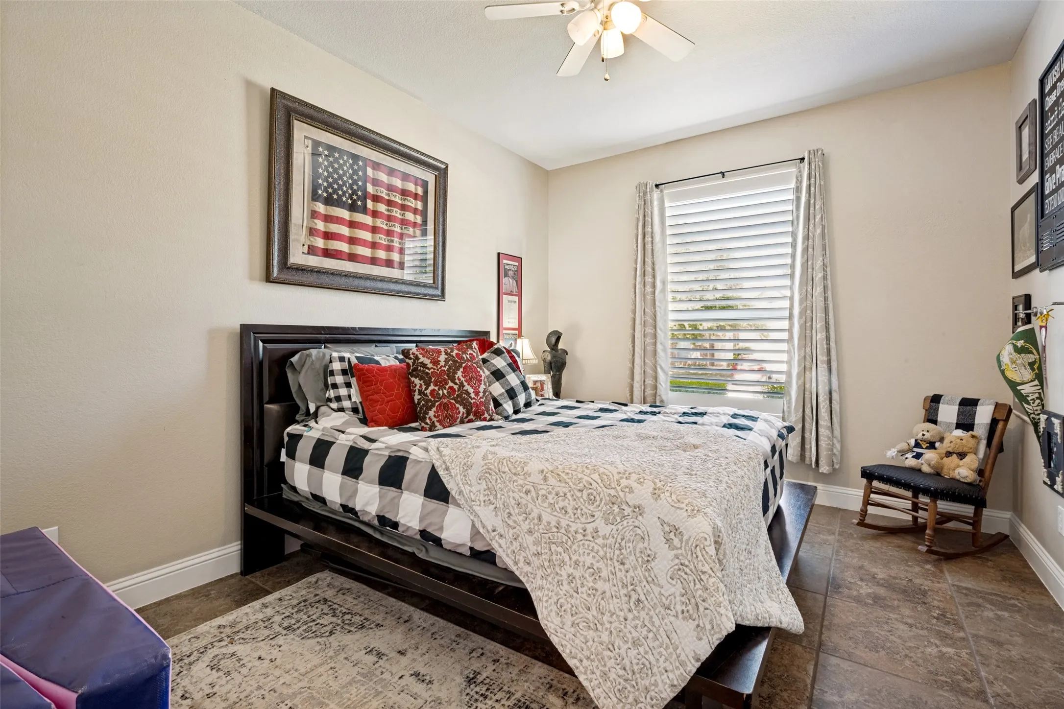 Spacious room featuring neutral-toned walls, a ceiling fan with integrated lighting, a window with horizontal blinds, and tile flooring