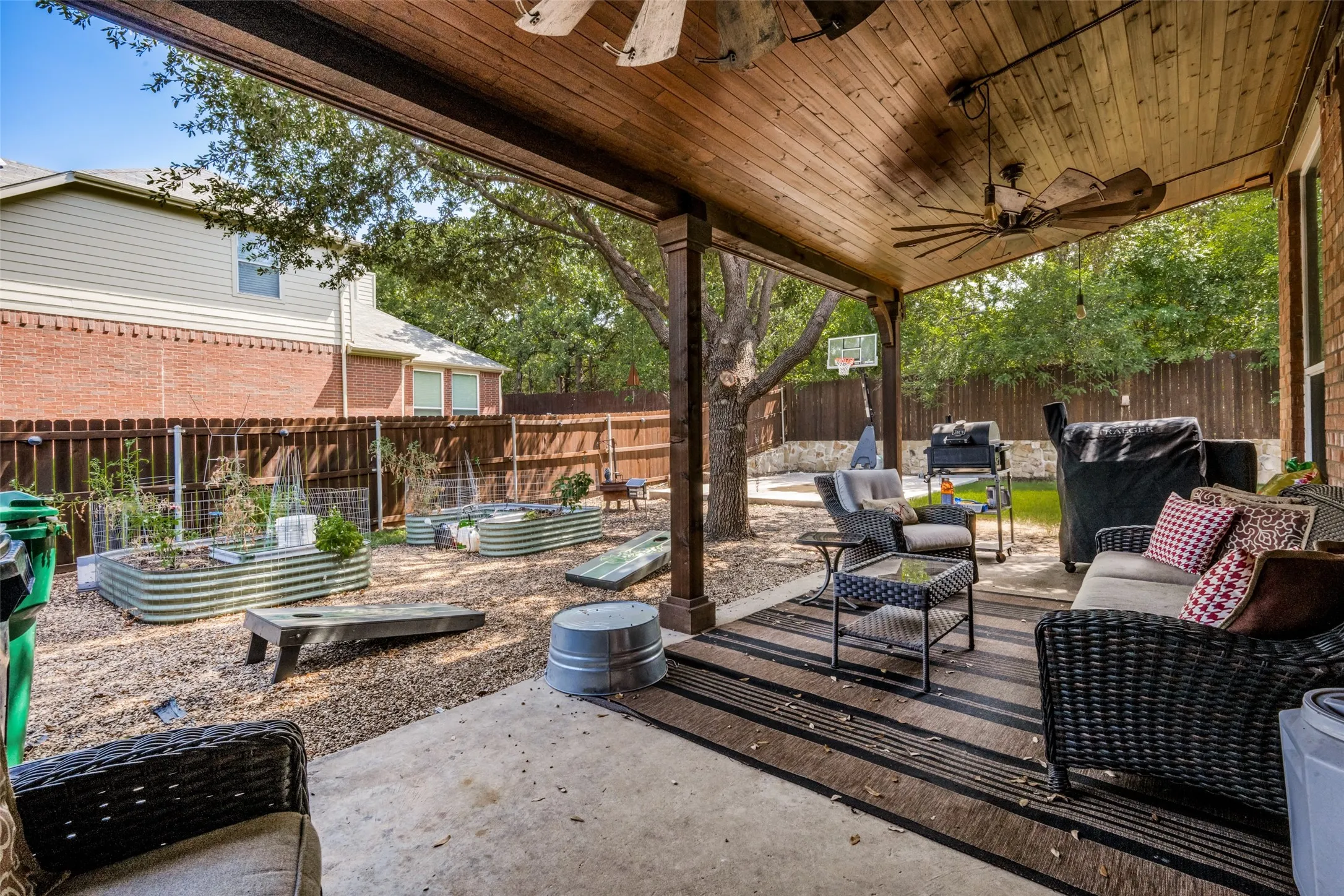 Covered patio with a wood-plank ceiling and a ceiling fan