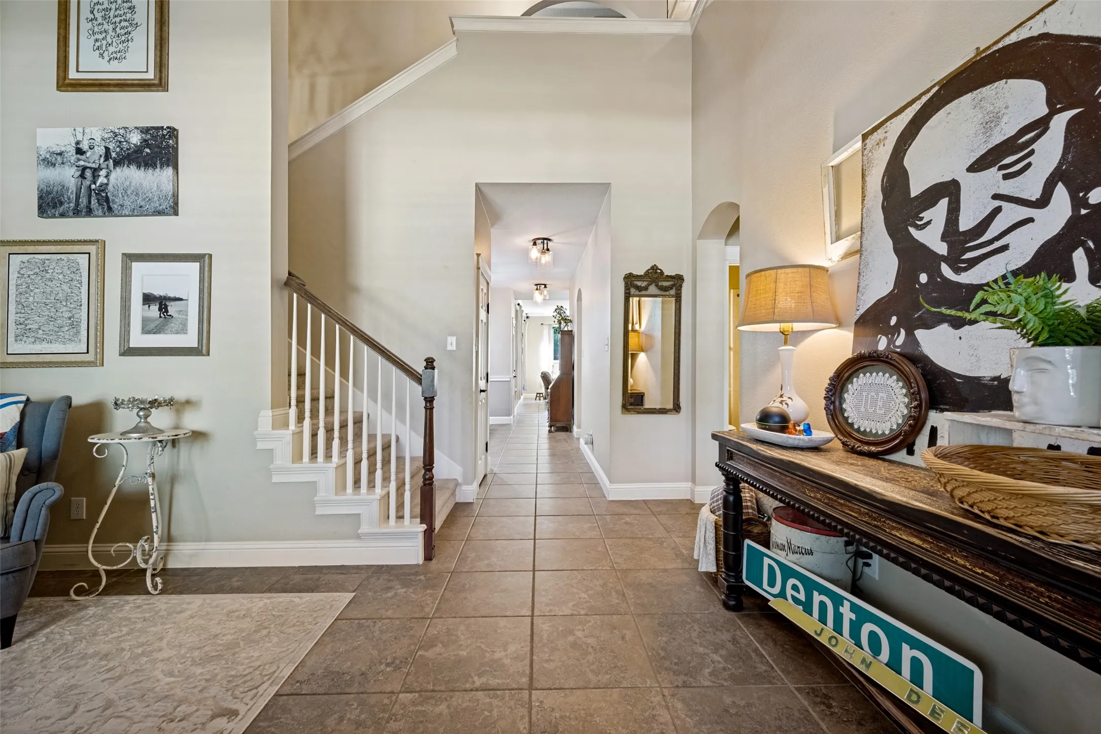 Tiled flooring throughout the main corridor leading to an arched doorway