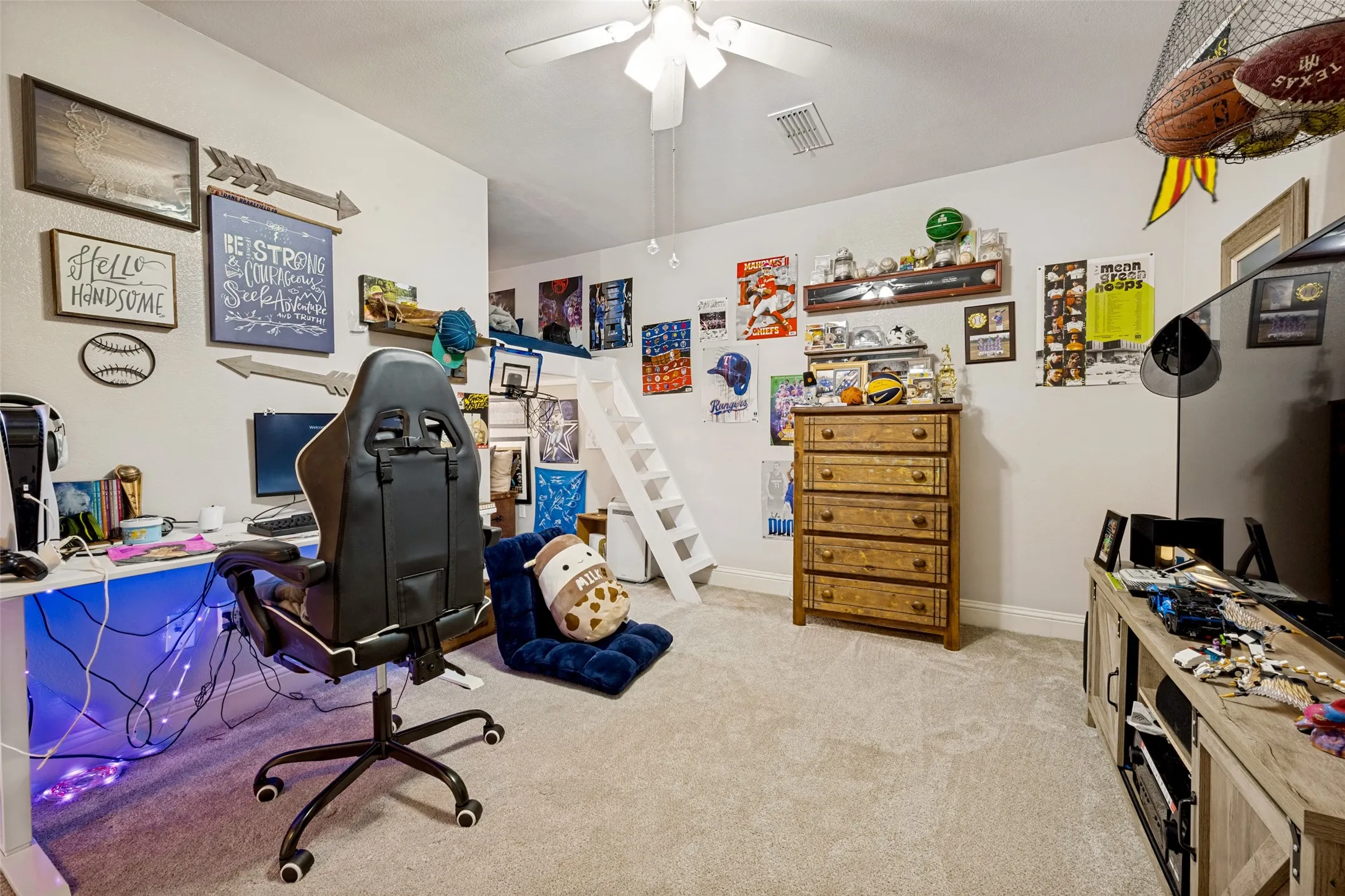 Carpeted room featuring a ceiling fan, built-in loft bed with a ladder, and light-toned walls