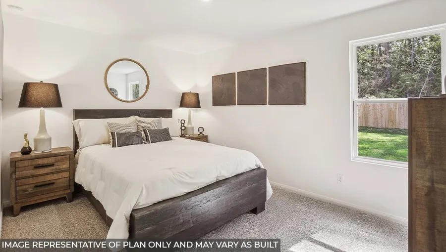 Plush carpeted flooring and white painted walls provide a neutral palette