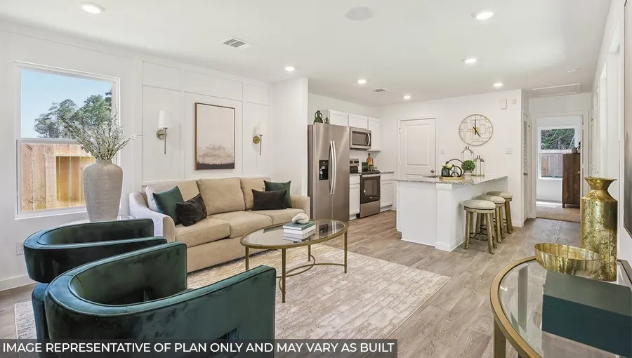 Open-concept living space featuring wood-finish flooring, recessed lighting, and a kitchen island with seating