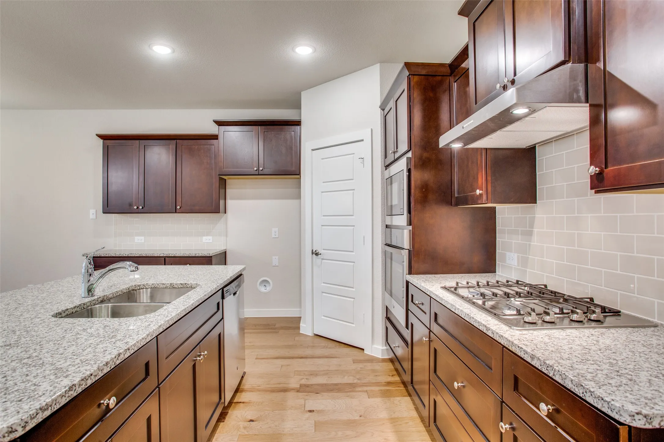 Granite counters and rich dark cabinetry