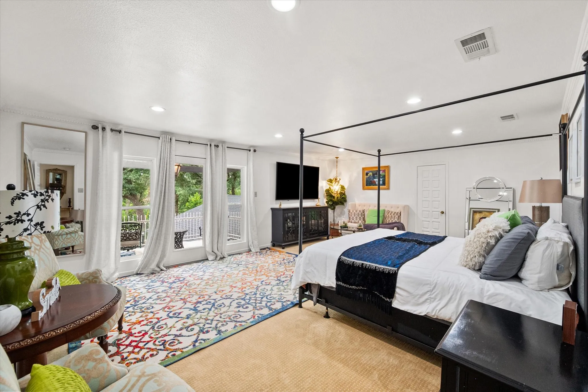 Spacious room featuring multiple French doors providing abundant natural light, recessed ceiling lighting, and light-colored wall finishes