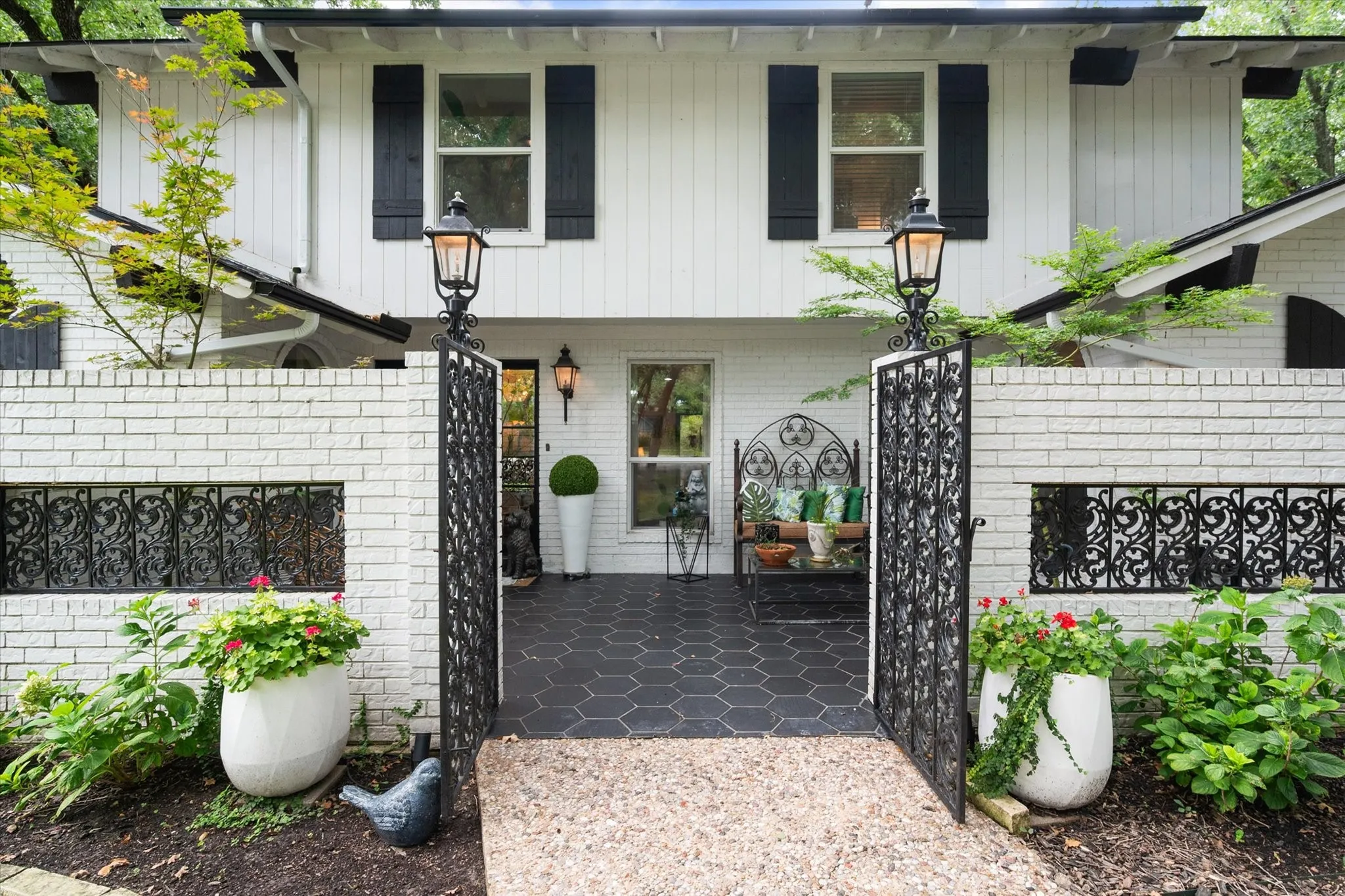 Architectural white brick facade with black trim and upper-level siding