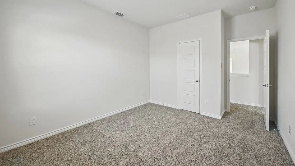 Carpeted room featuring light-colored walls and white trim