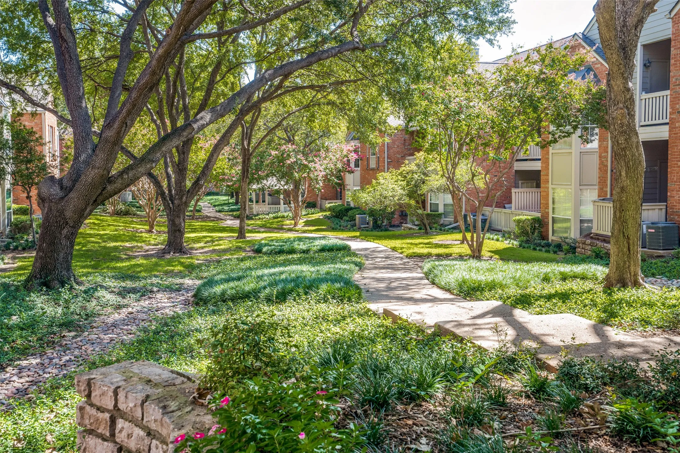 Lush landscaping with mature trees throughout the community