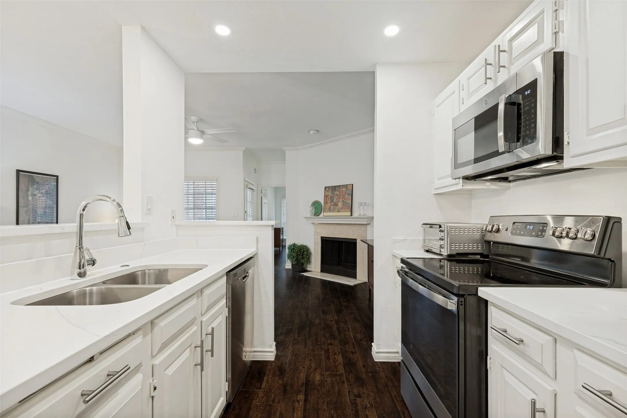Kitchen featuring white cabinetry and counter-tops, stainless steel appliances