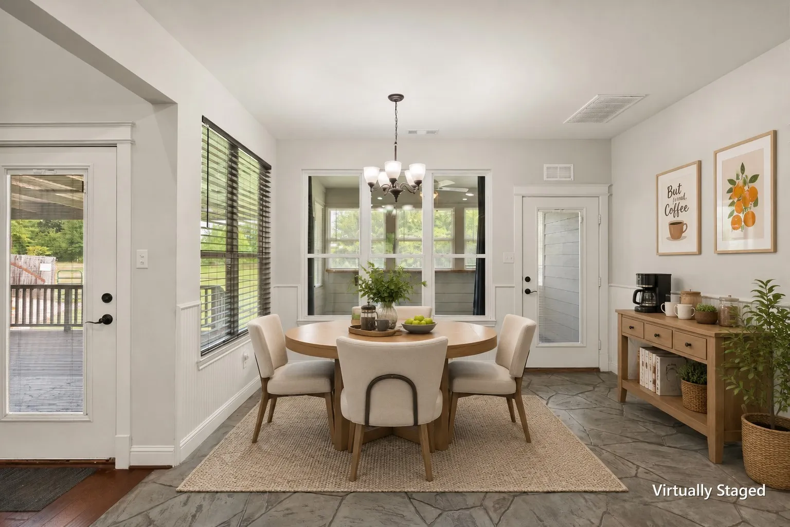 Virtually staged breakfast nook with modern farmhouse furnishings, backyard views and convenient access to the covered porch.