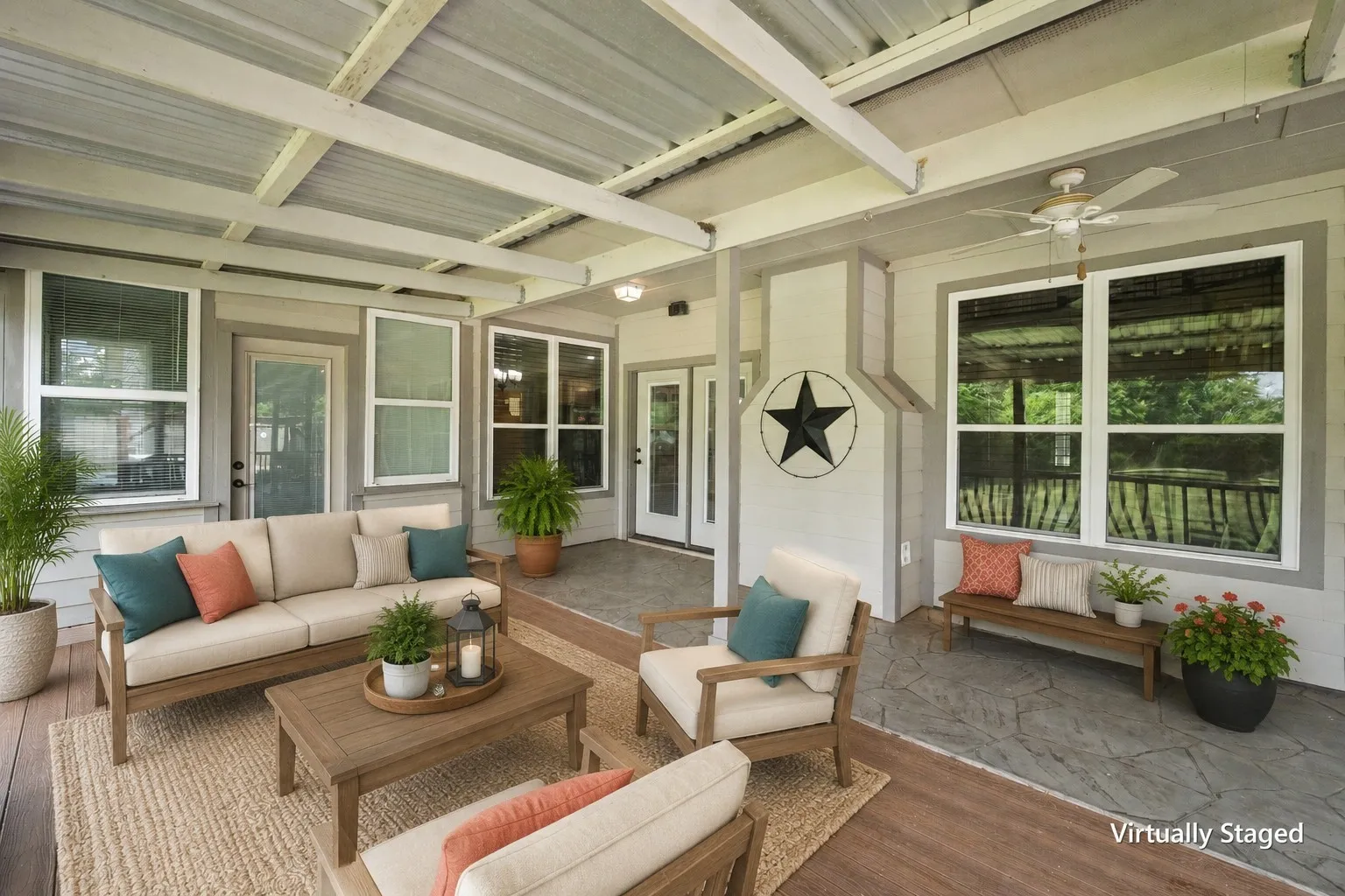 Virtually staged covered back porch with coordinated outdoor seating, ceiling fans and space for year-round entertaining.