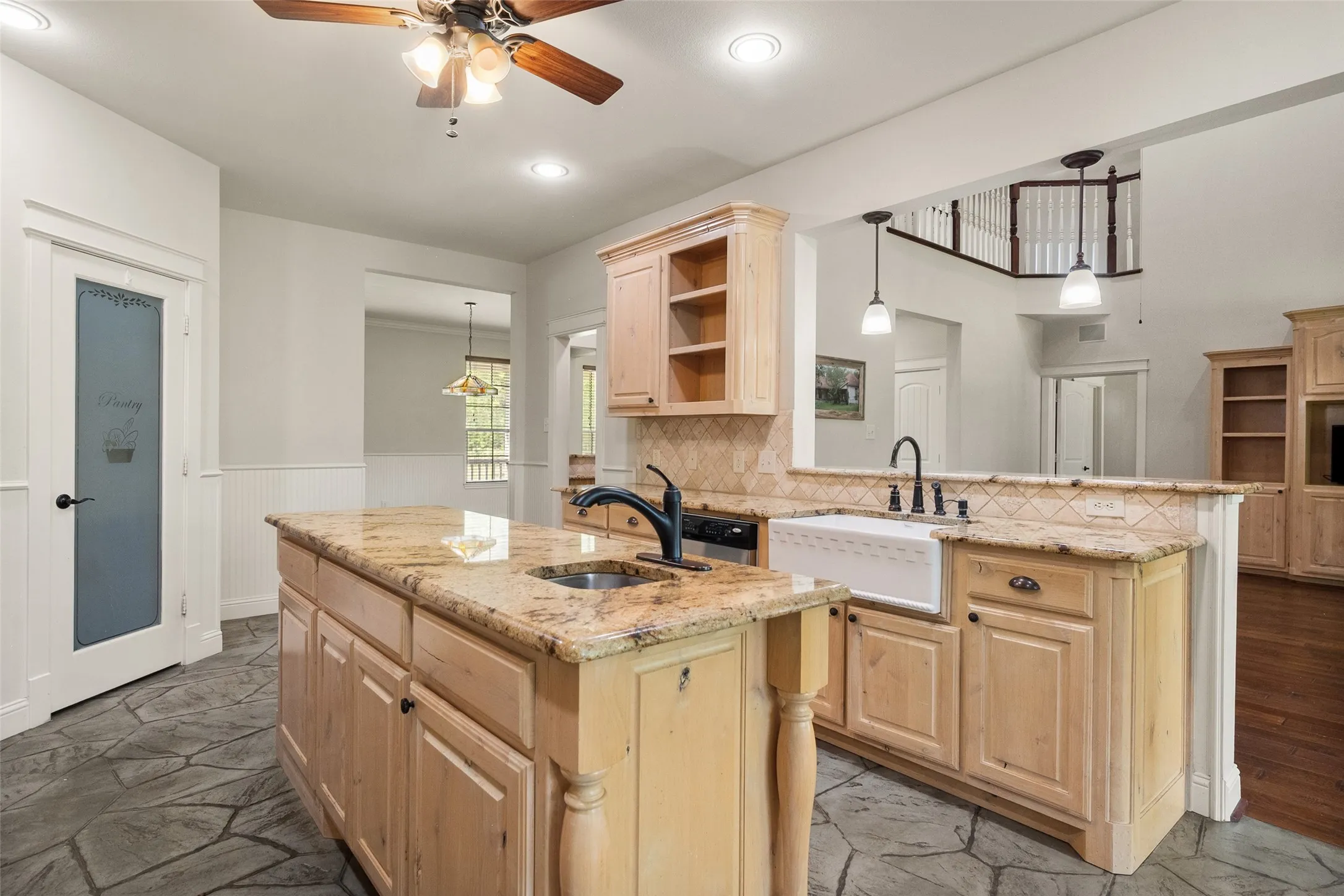 Open-concept kitchen with generous prep space, breakfast bar and easy flow into the main living areas.