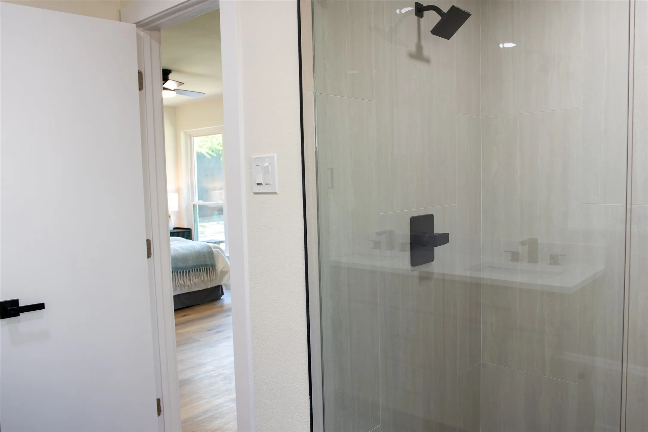 Master bathroom with a walk-in glass shower.”